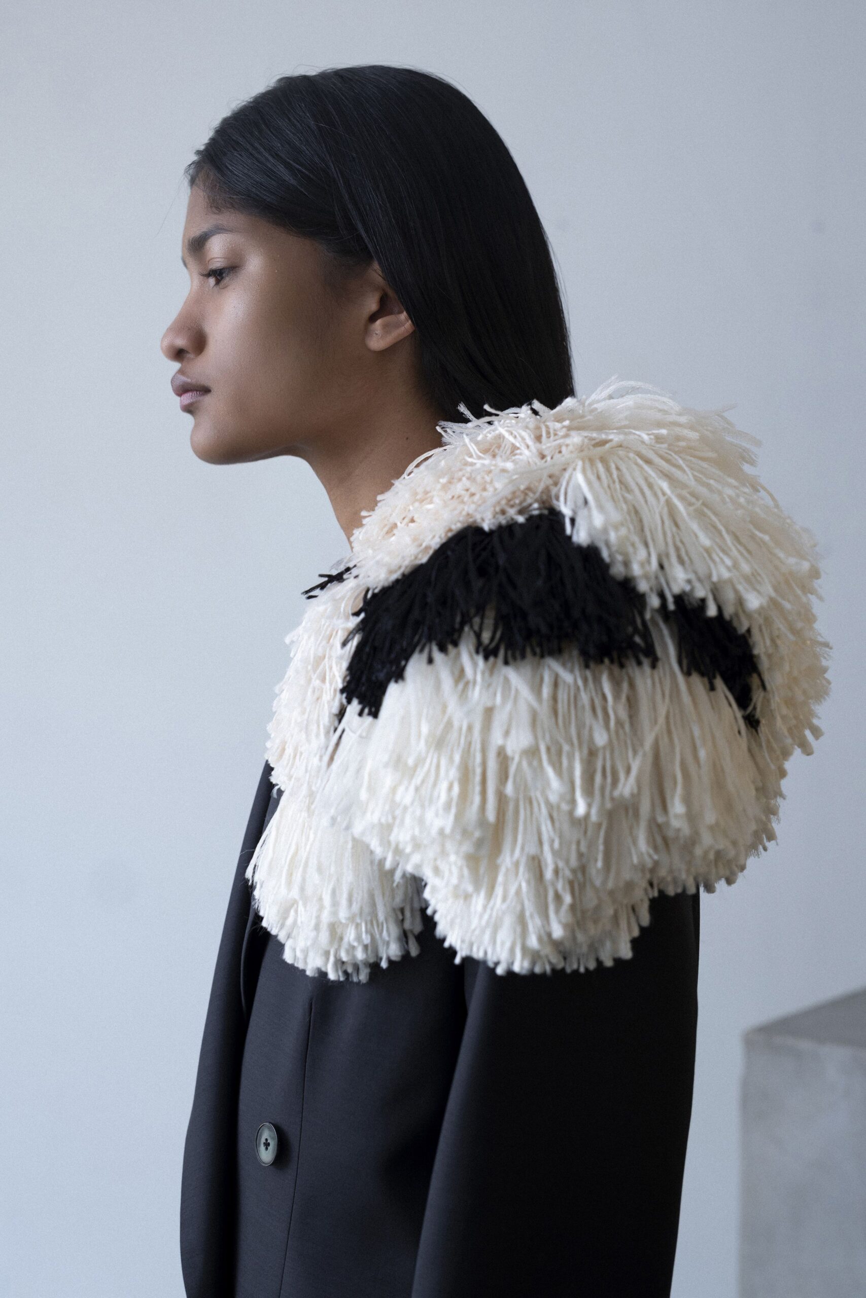 black structured blazer with fringed cape