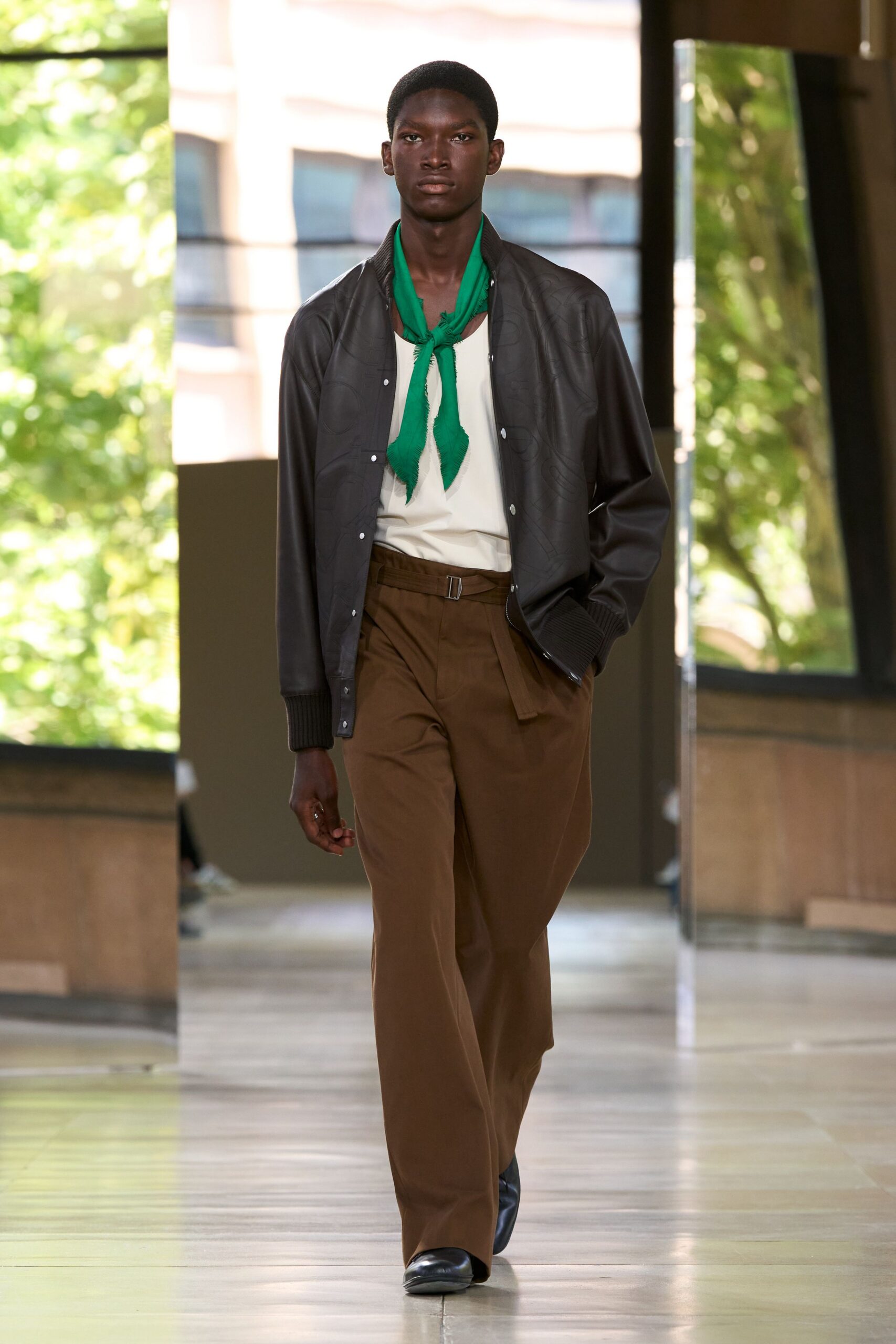 black leather jacket with green scarf