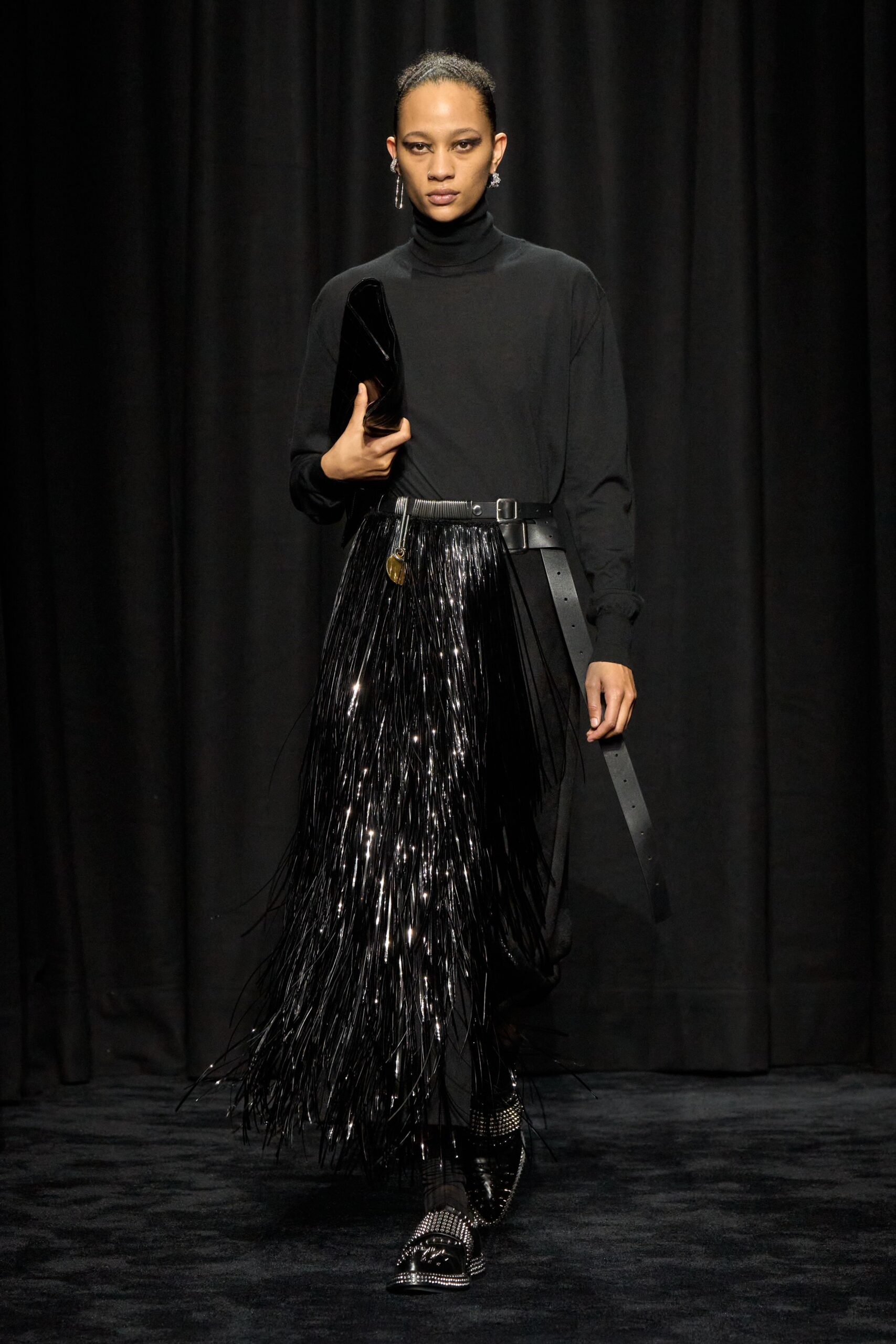black fitted top and fringed pants