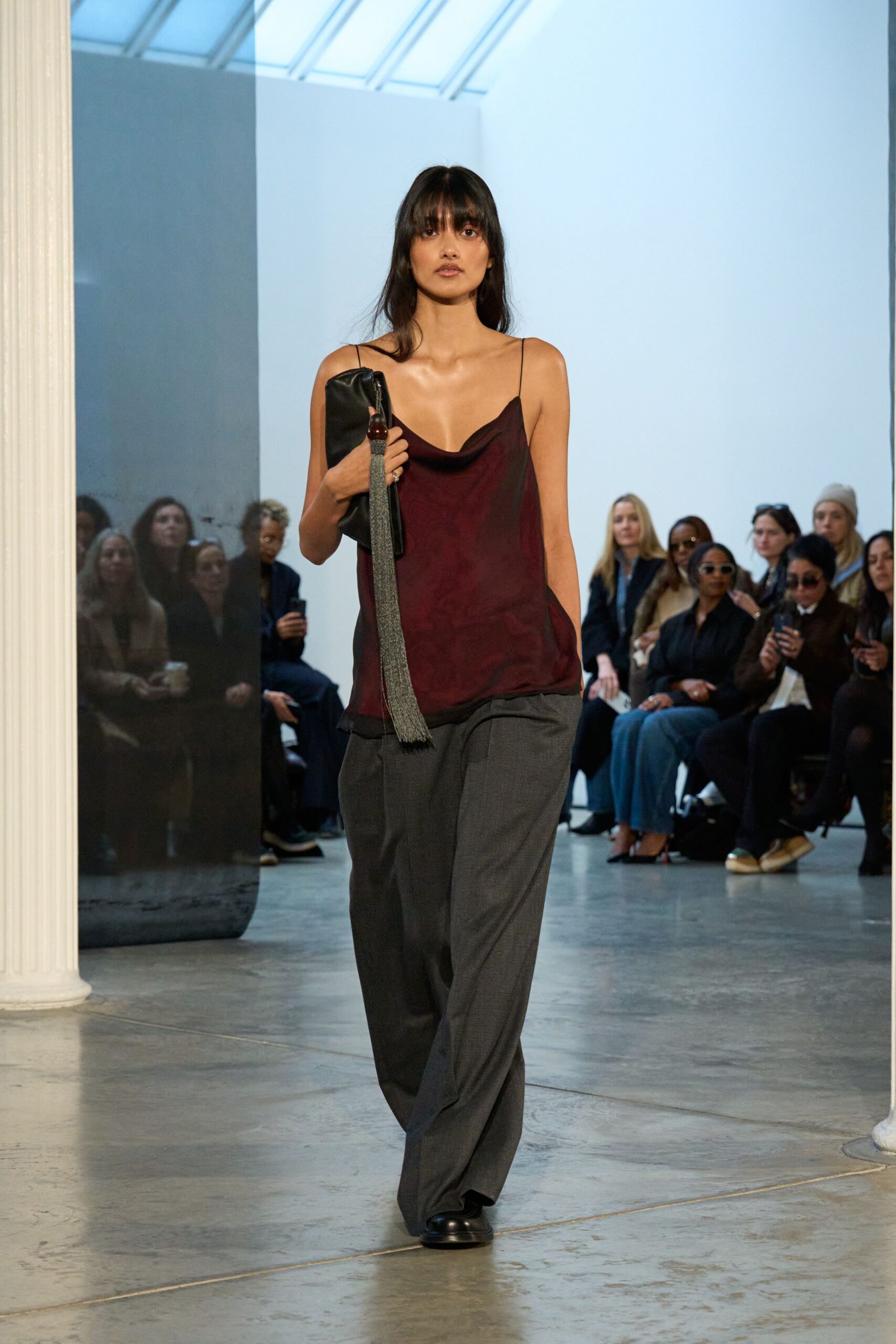 red silk sleeveless top with gray pants