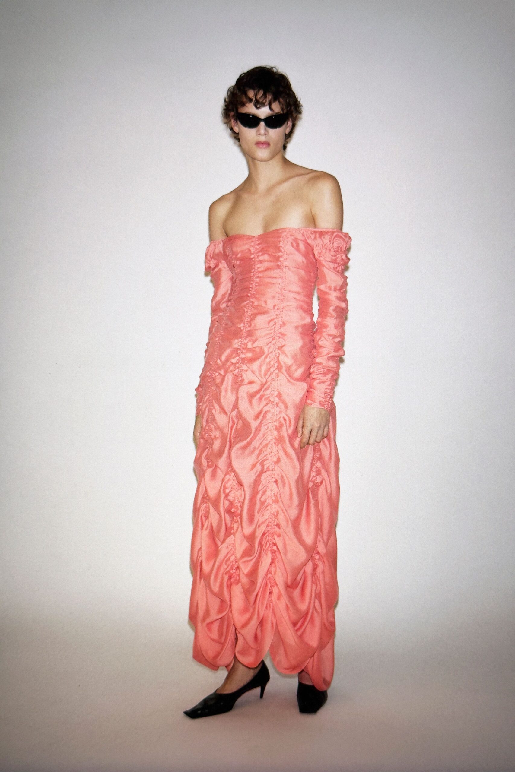 pink silk off-shoulder long-sleeve fitted ruched flowing gown