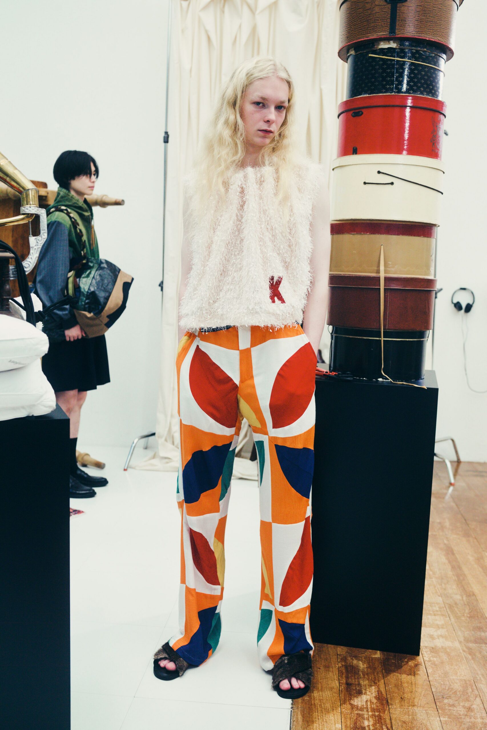 white ruffled top with multi pants