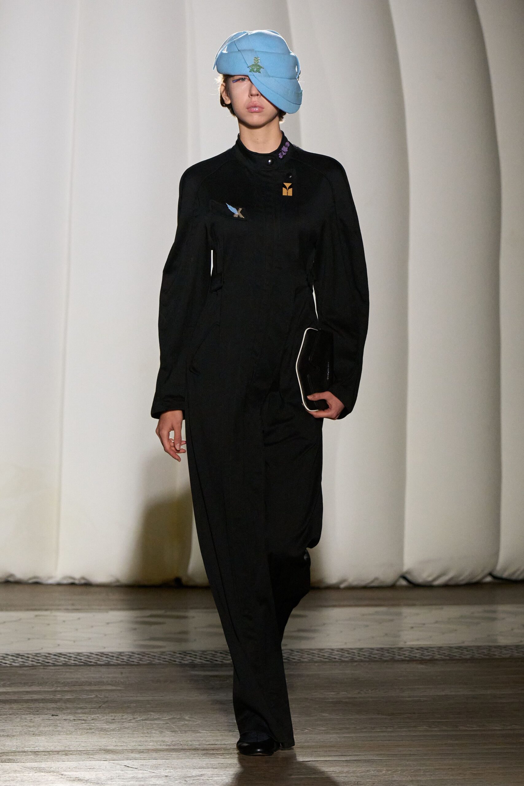 black fitted jumpsuit with blue hat