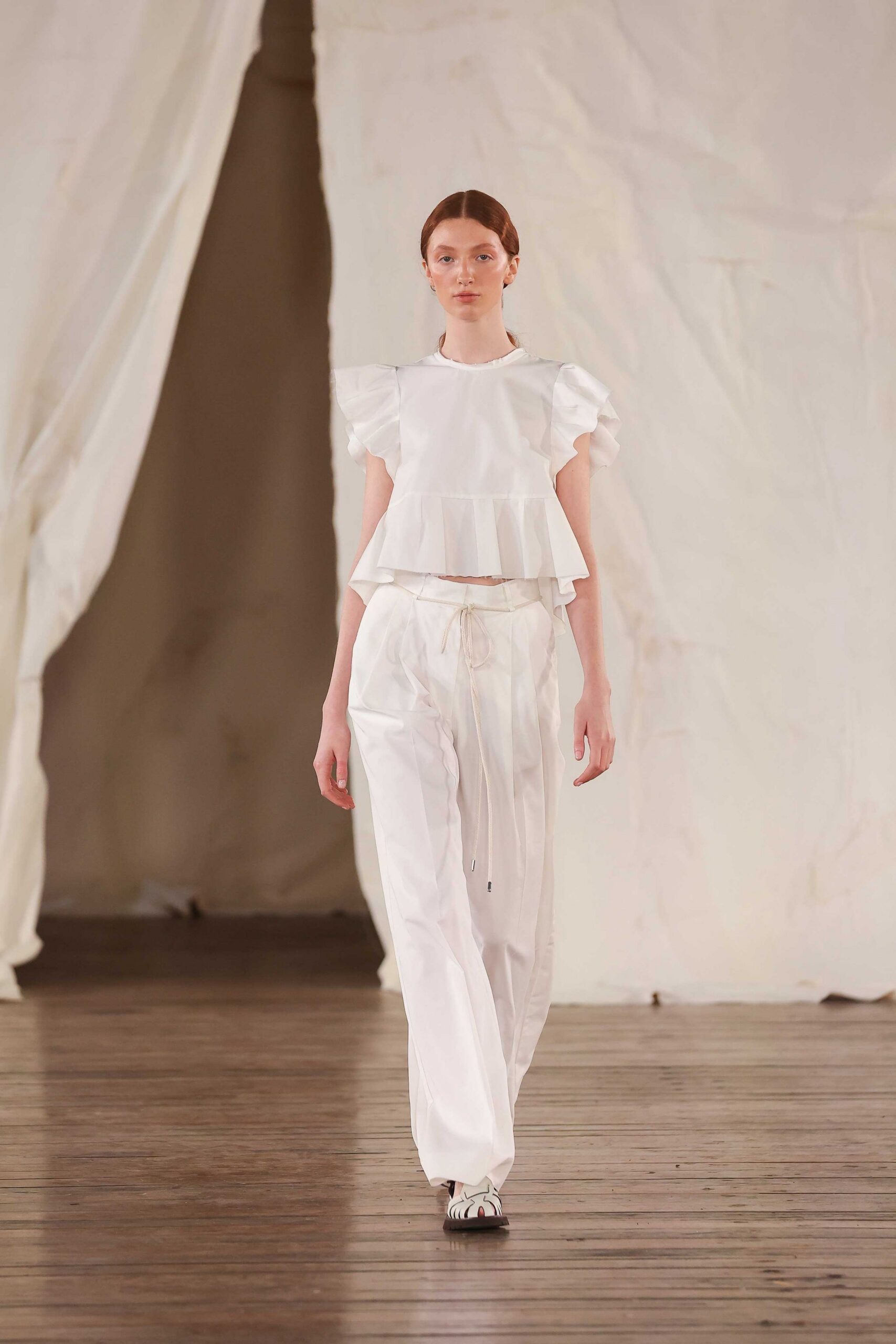 white ruffled top with relaxed pants