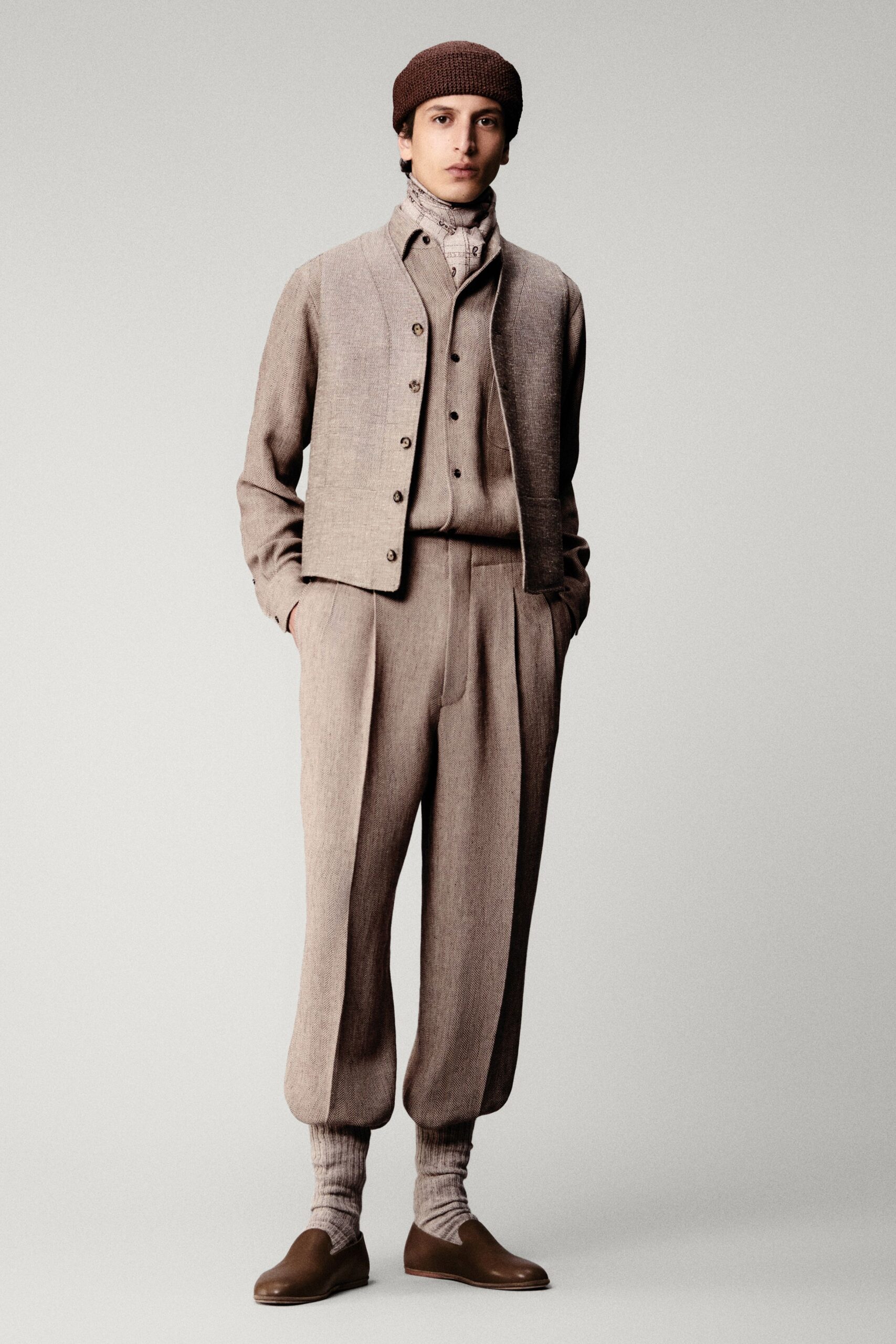 beige tailored vest with relaxed pants