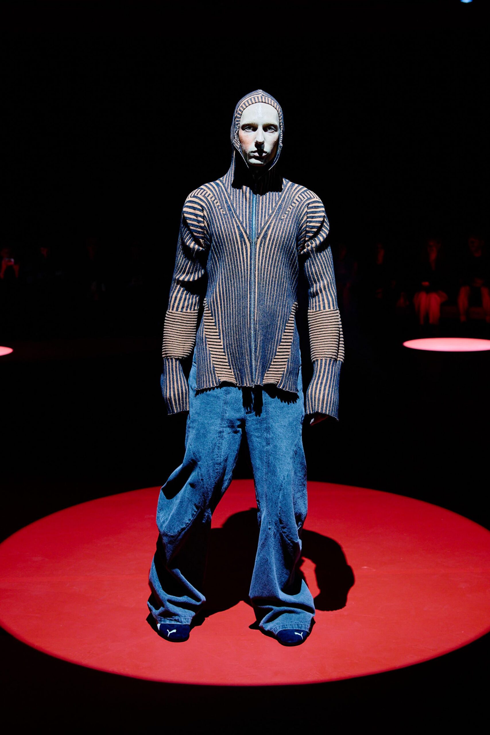 striped black and blue sweater with relaxed denim pants