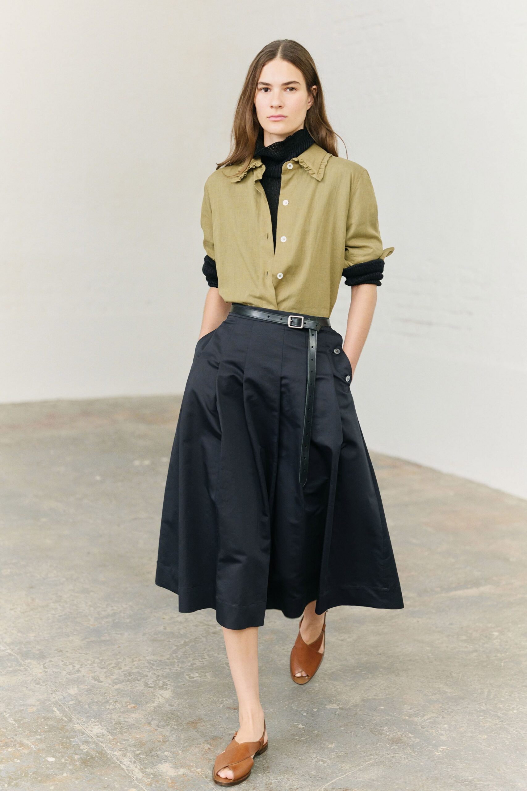 green shirt black pleated skirt