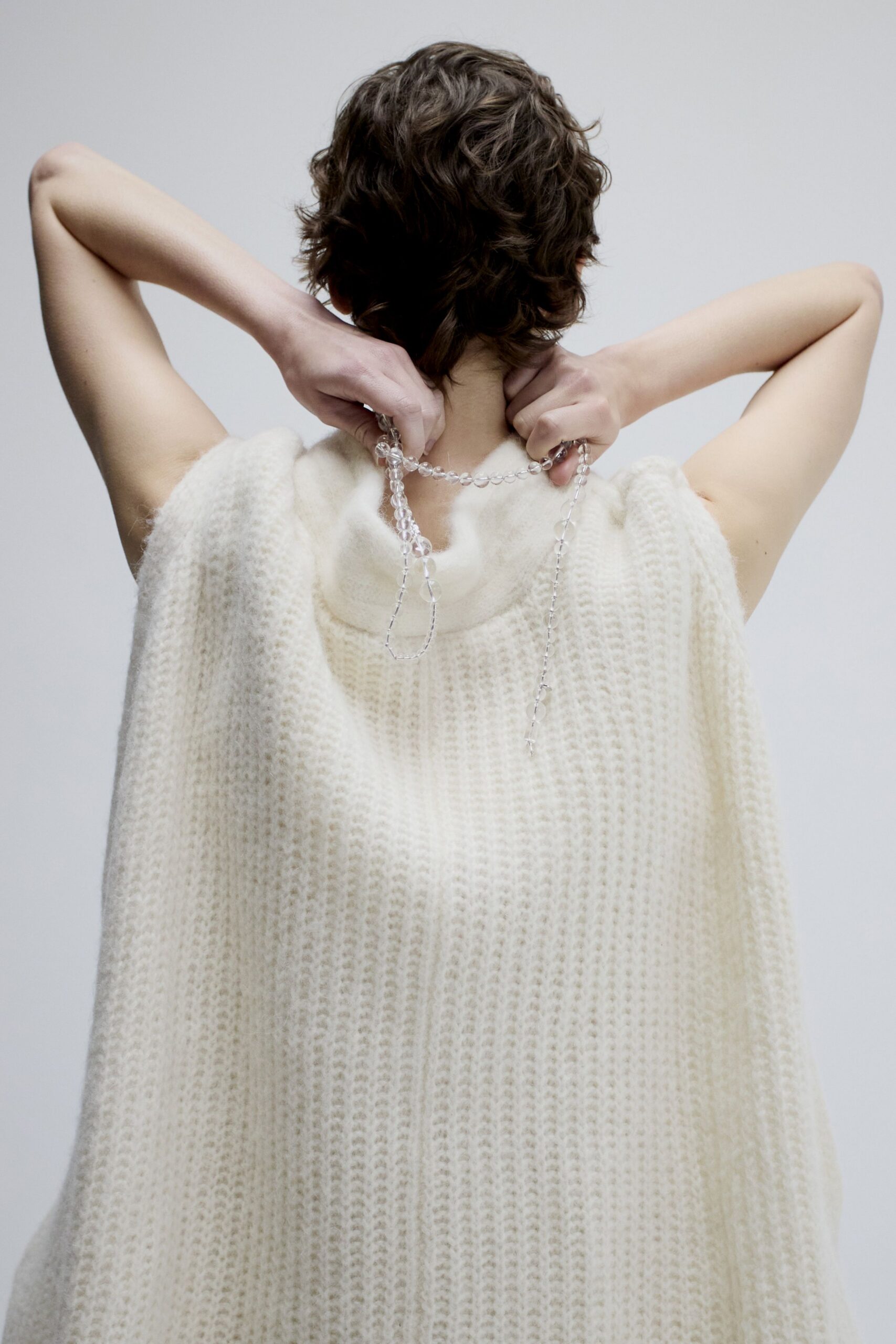 white knitted sleeveless cape