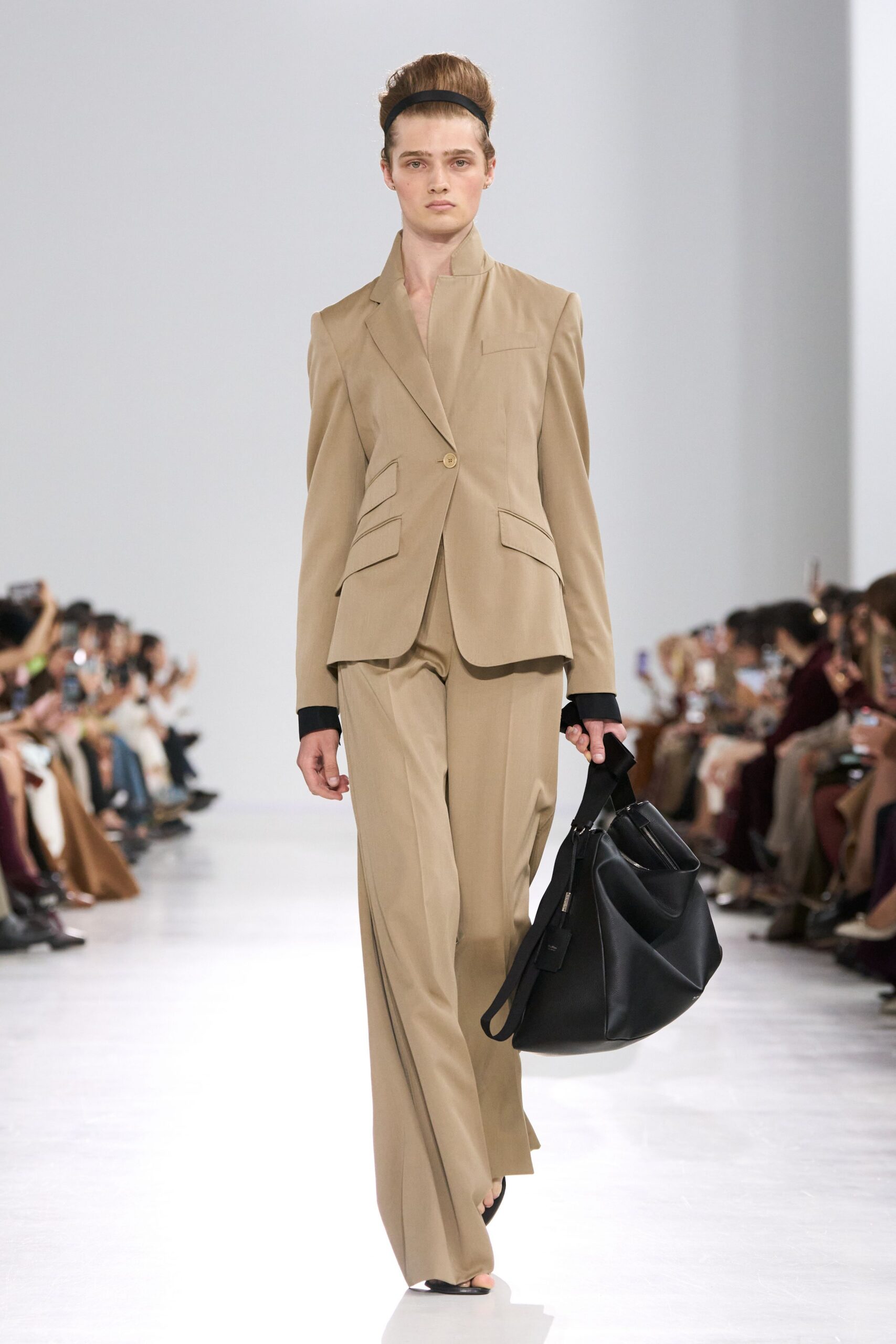 beige tailored suit with black bag