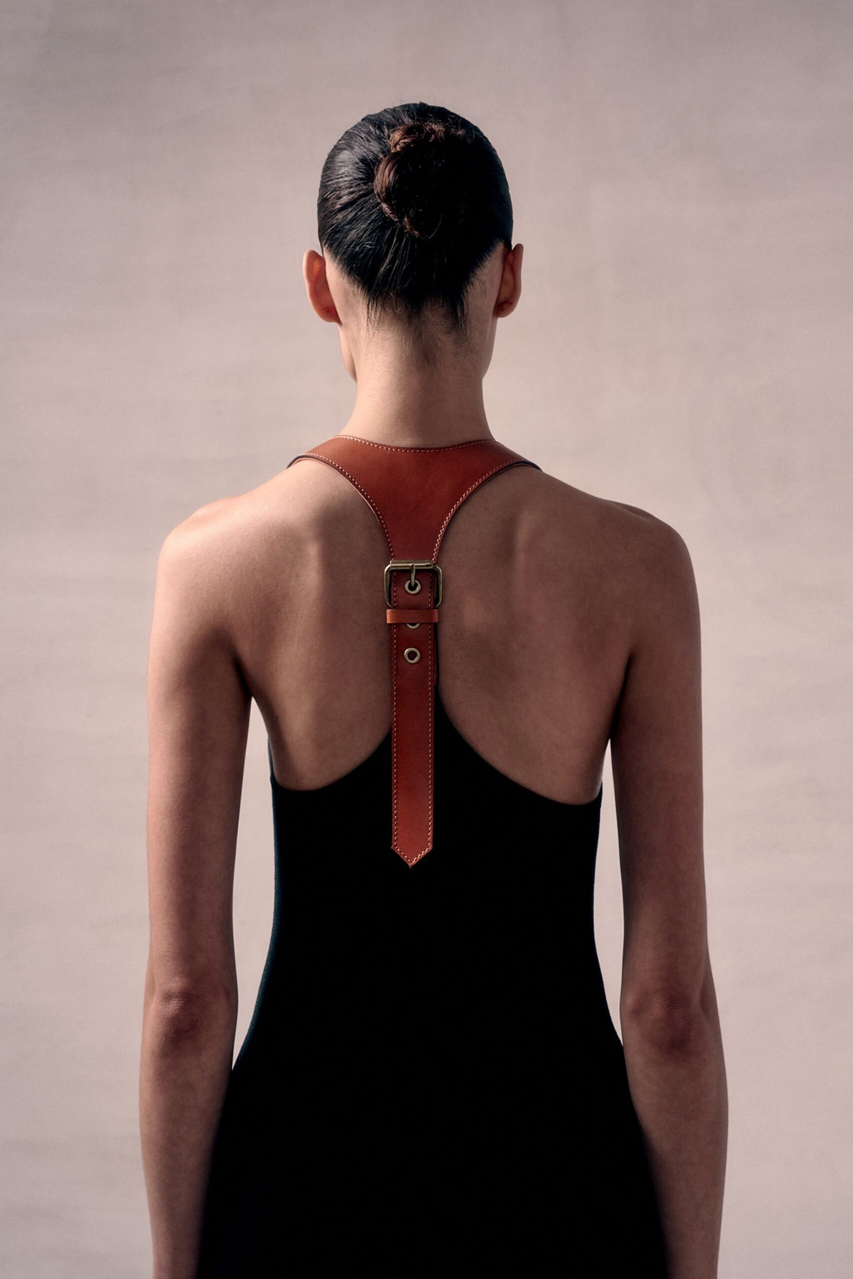 black fitted dress with brown belt