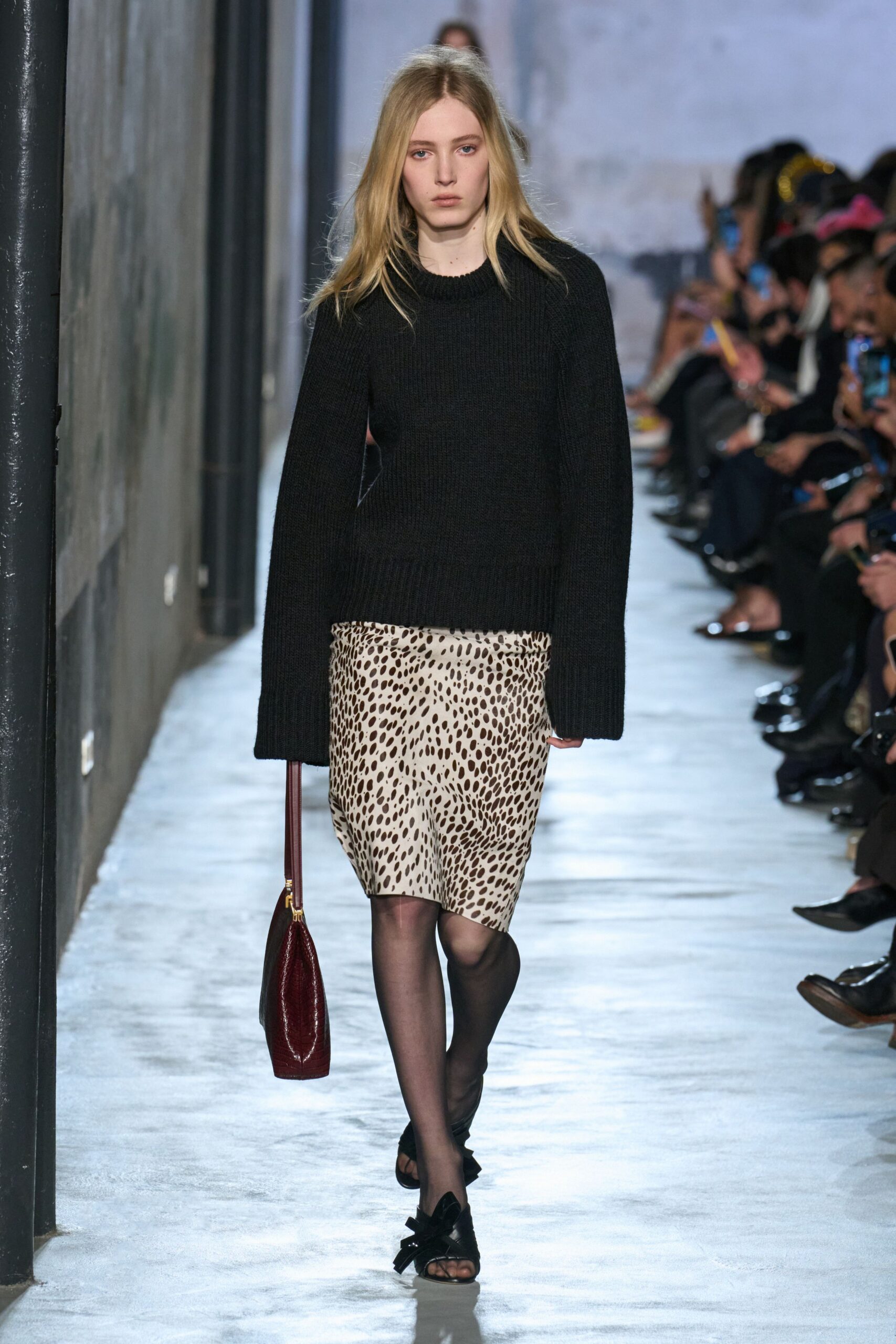 black oversized sweater with animal-print skirt