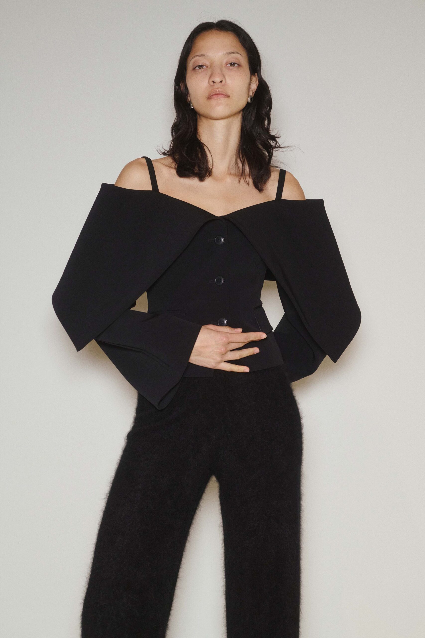 black off-shoulder top and relaxed pants