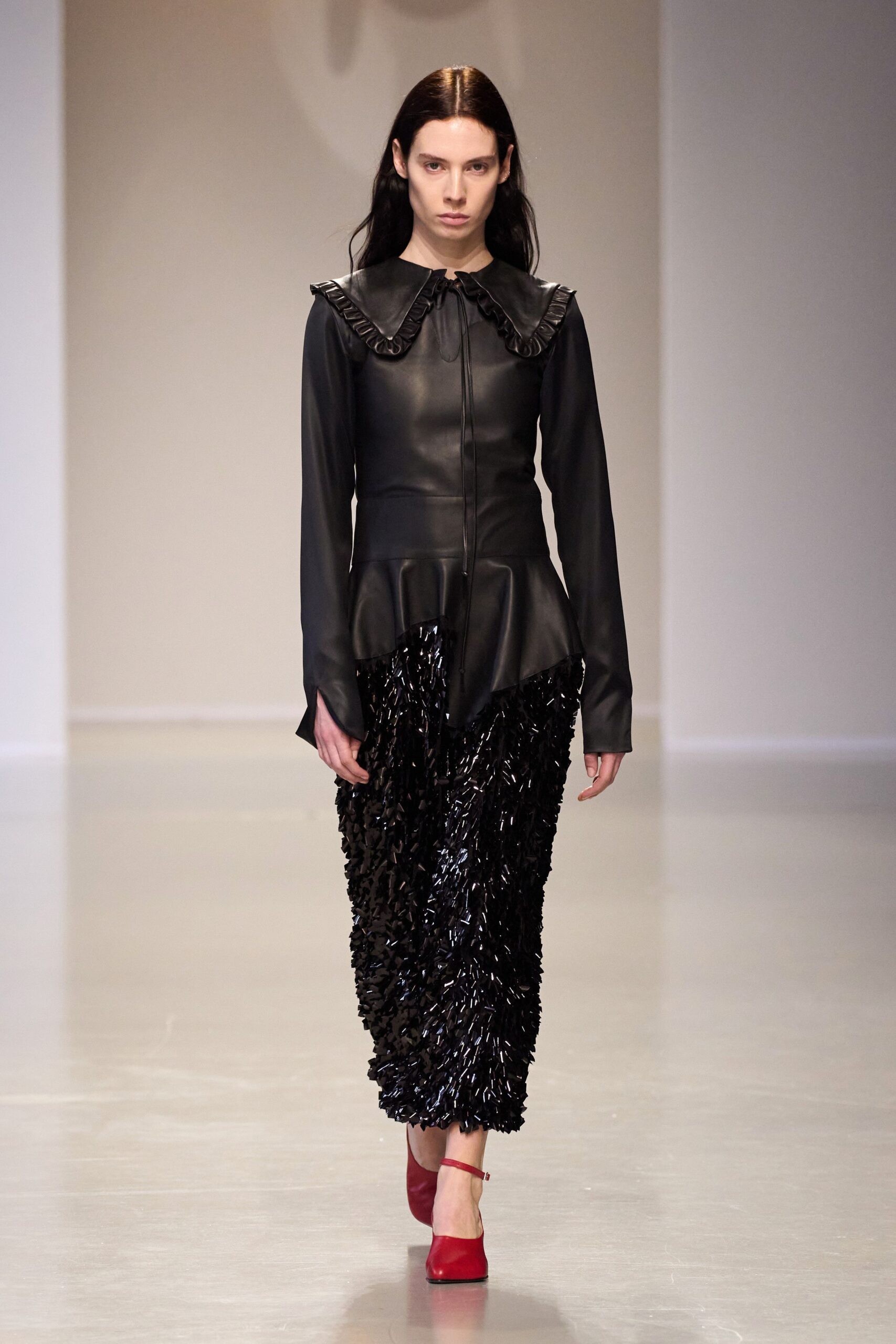 black leather shirt and pleated skirt