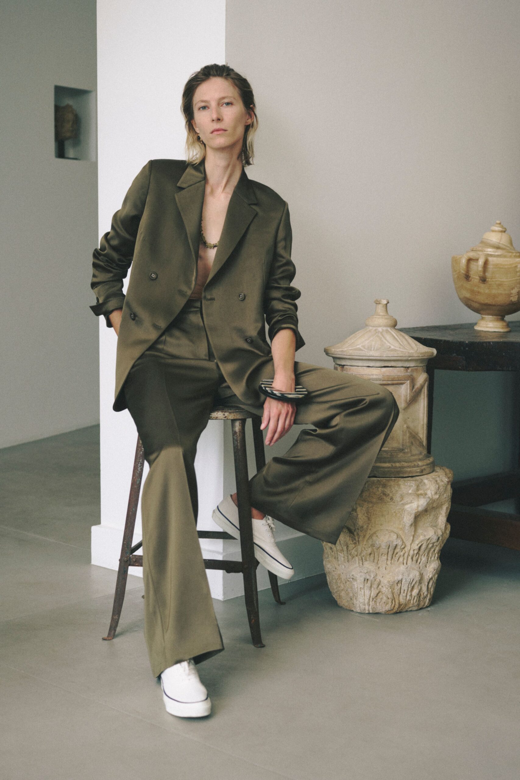 green tailored suit with white shoes