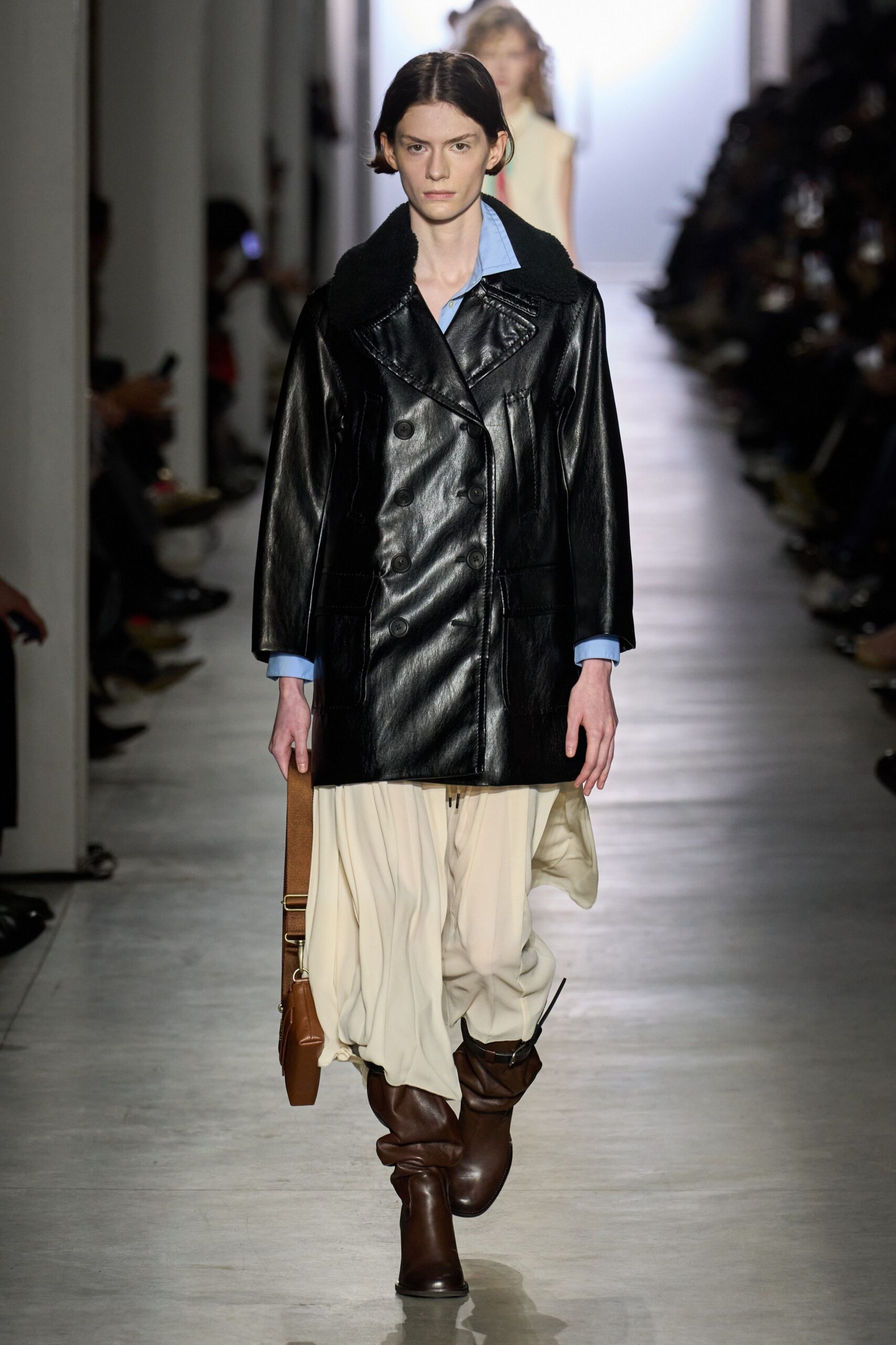 black leather coat with beige skirt
