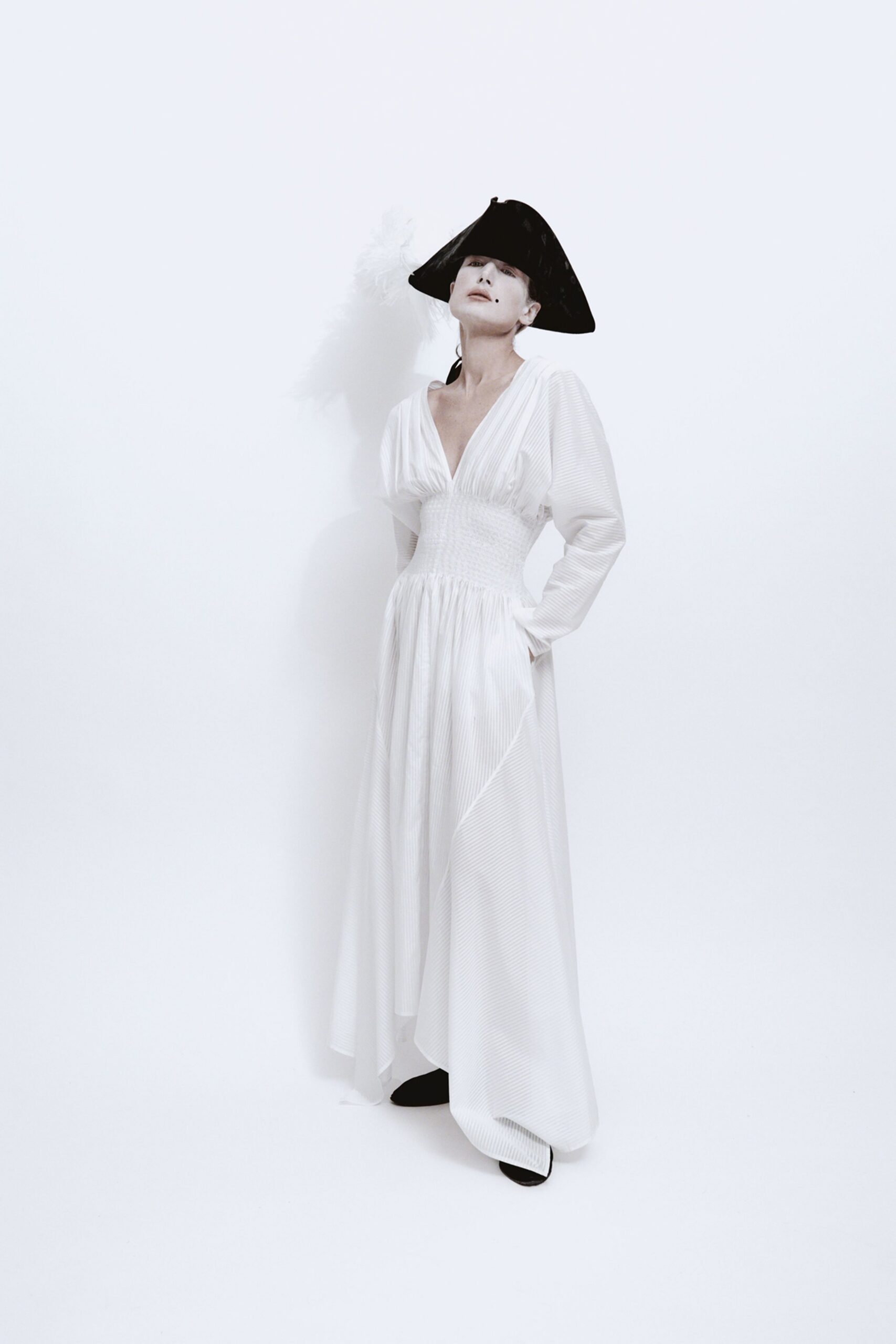 white fitted gown with black hat