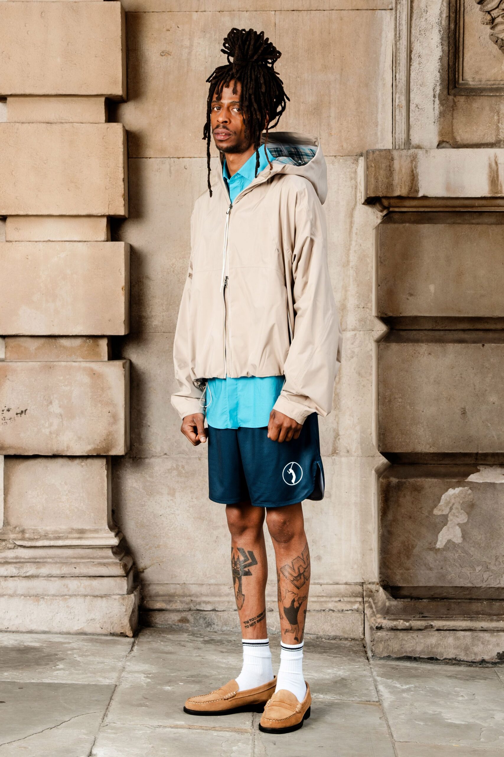 beige jacket blue shirt navy shorts