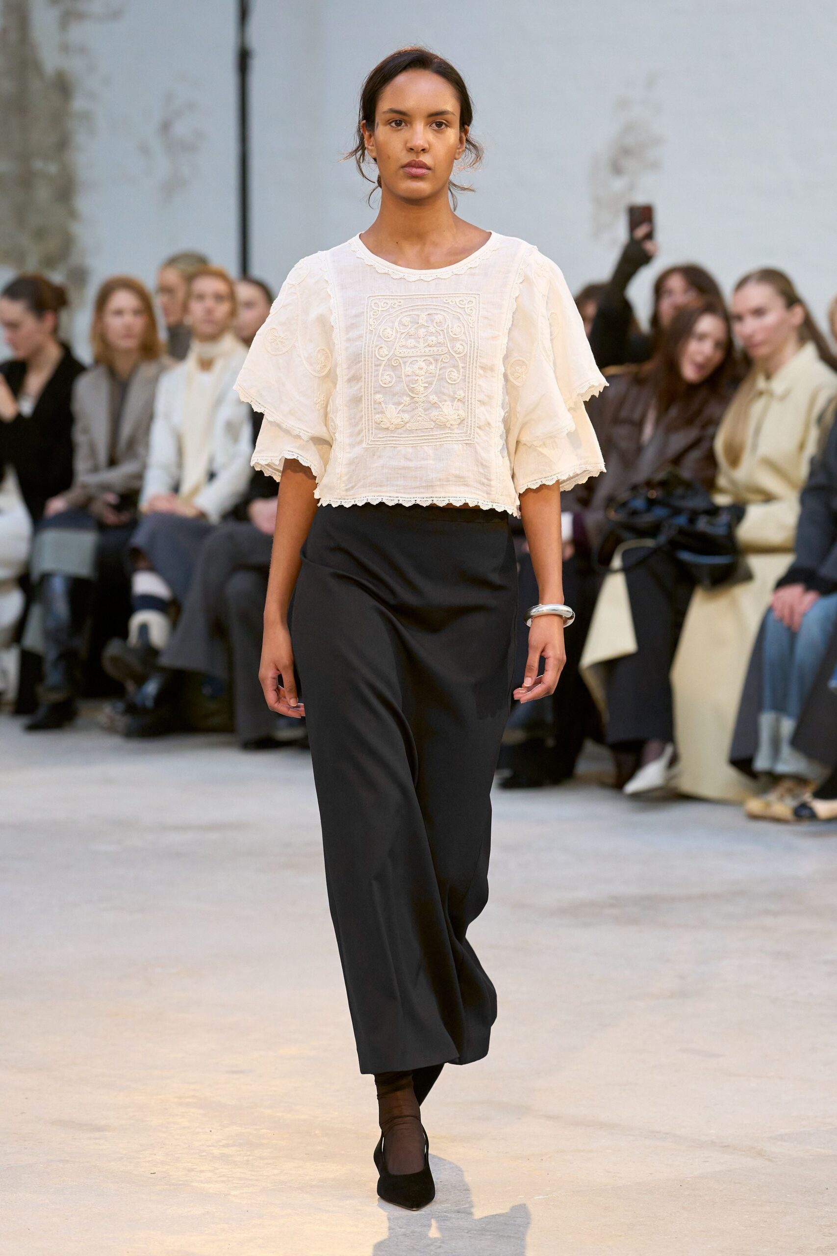 white embroidered top with black pants