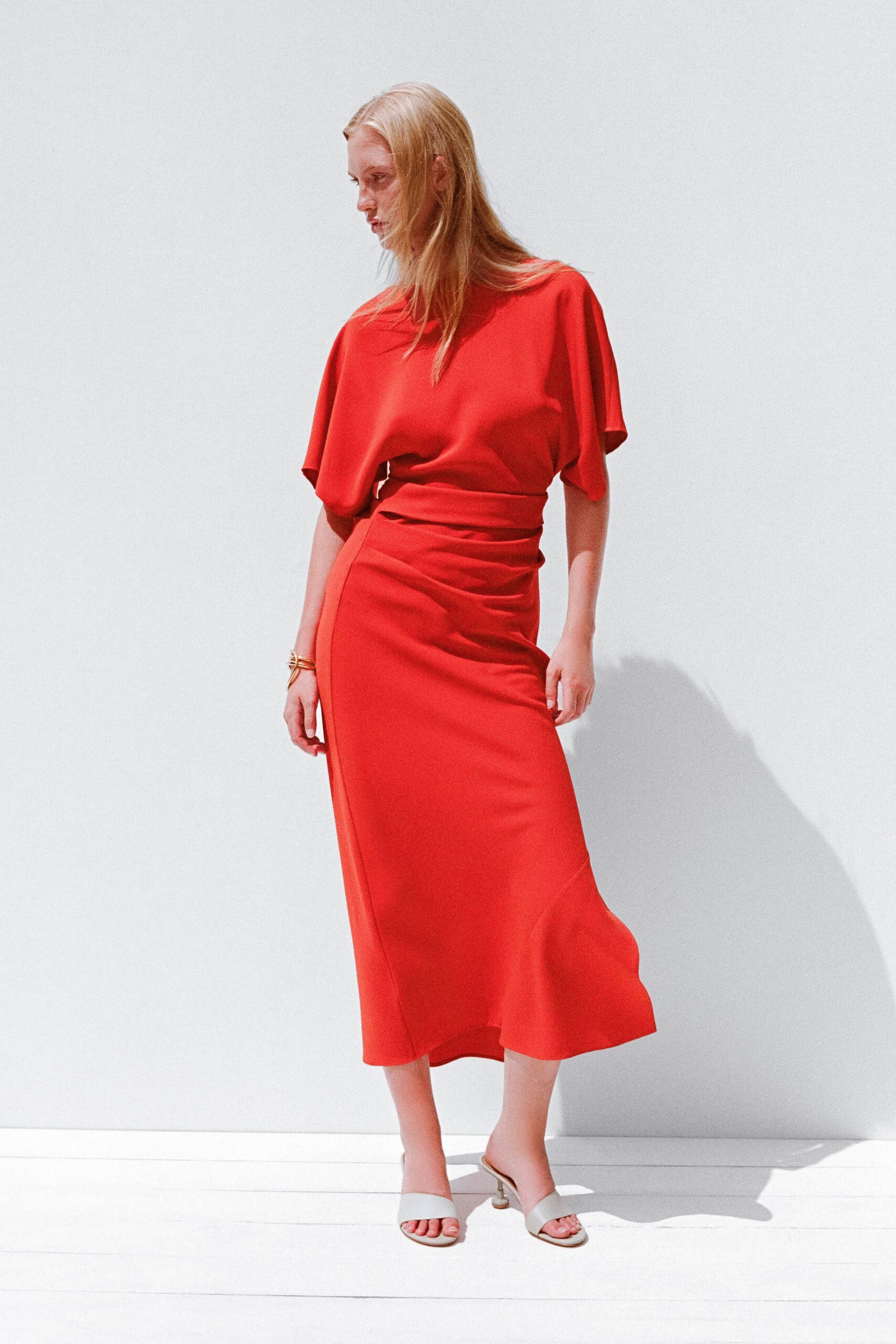 red silk short-sleeve high-neck fitted draped tiered dress