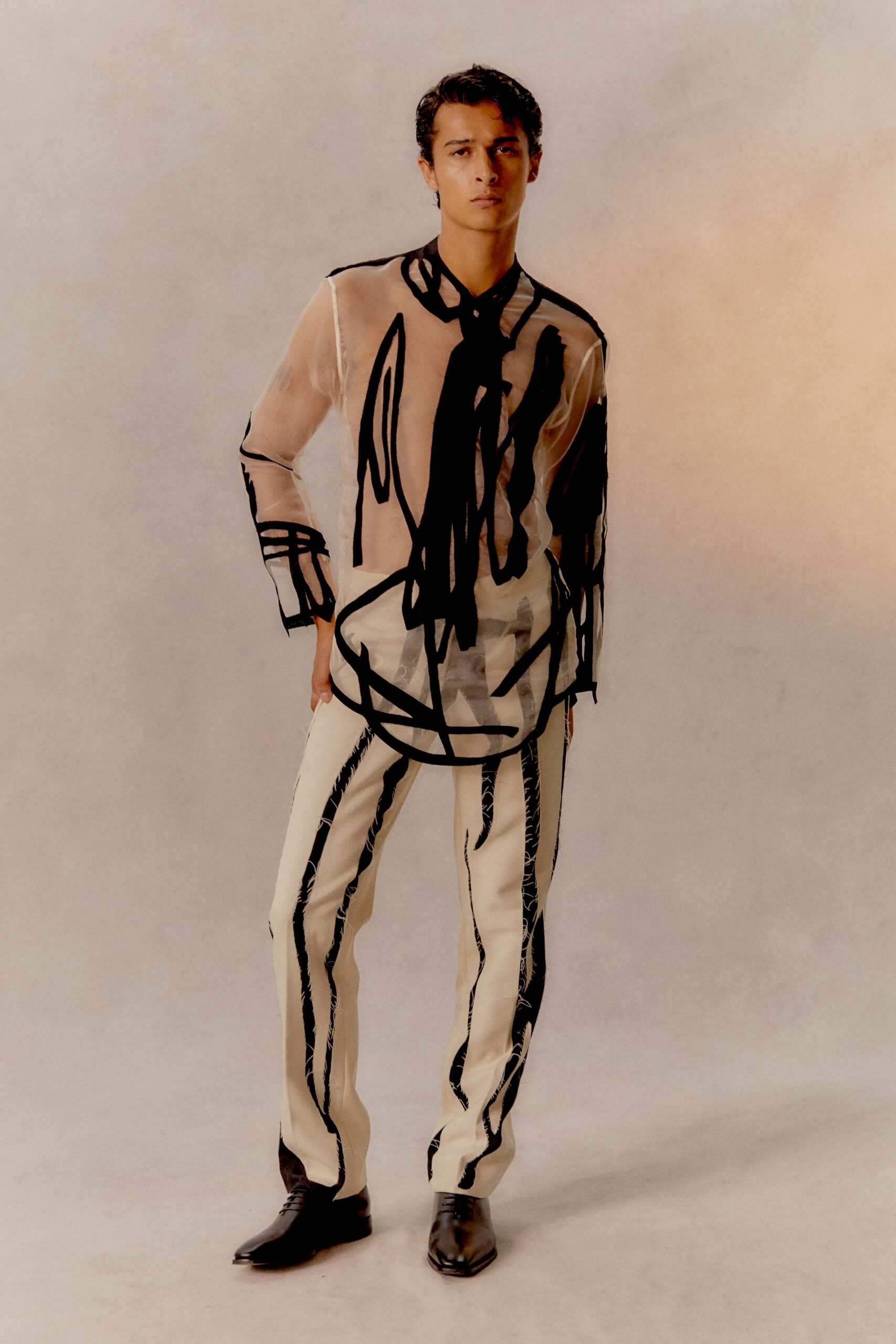 sheer black and white shirt with striped pants