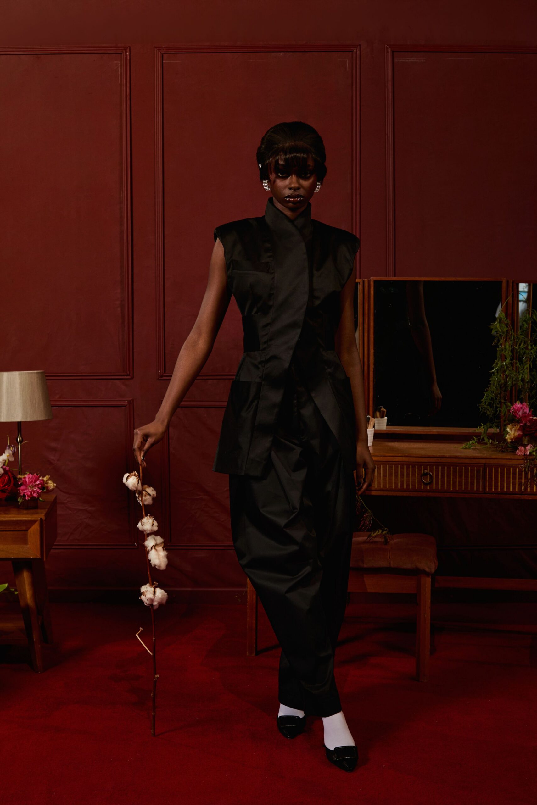 black fitted jumpsuit with sunglasses