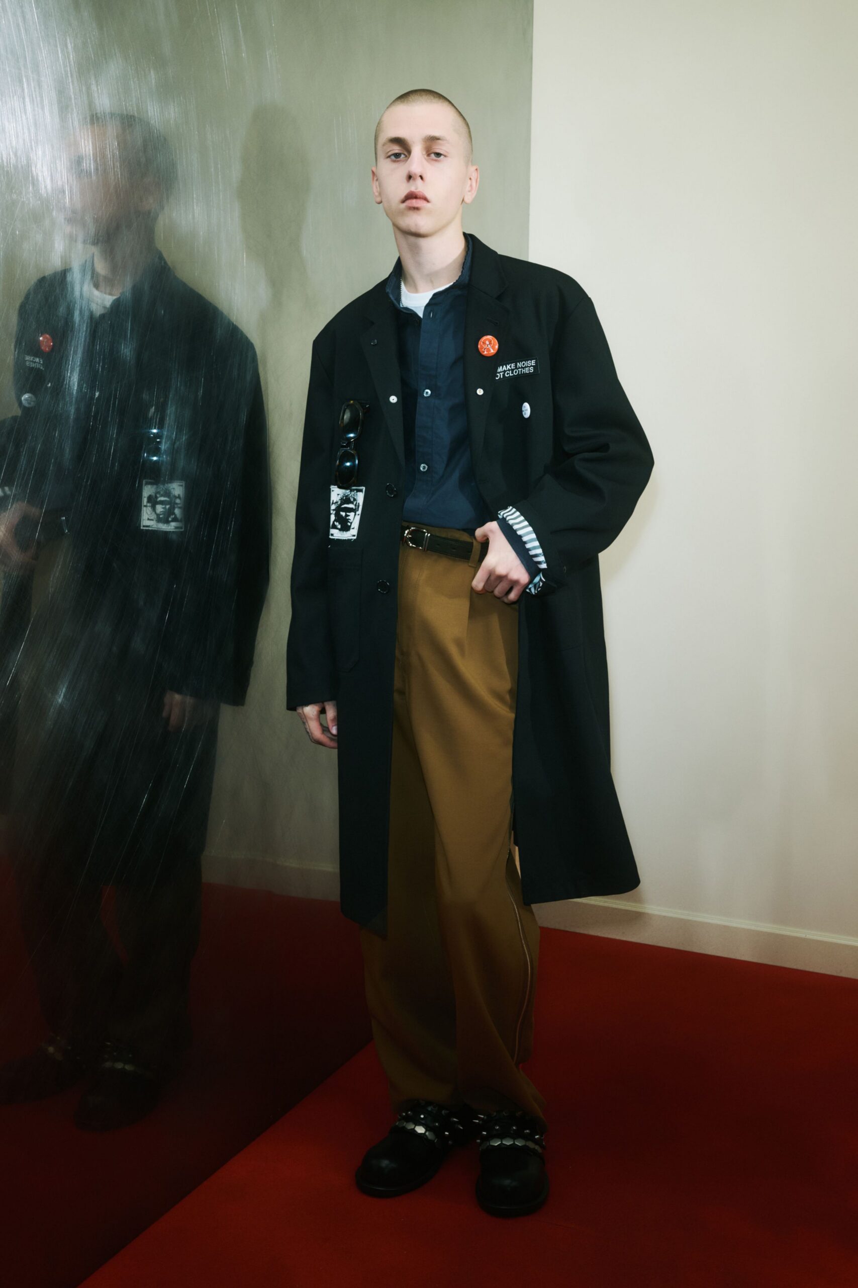 black coat blue shirt brown pants
