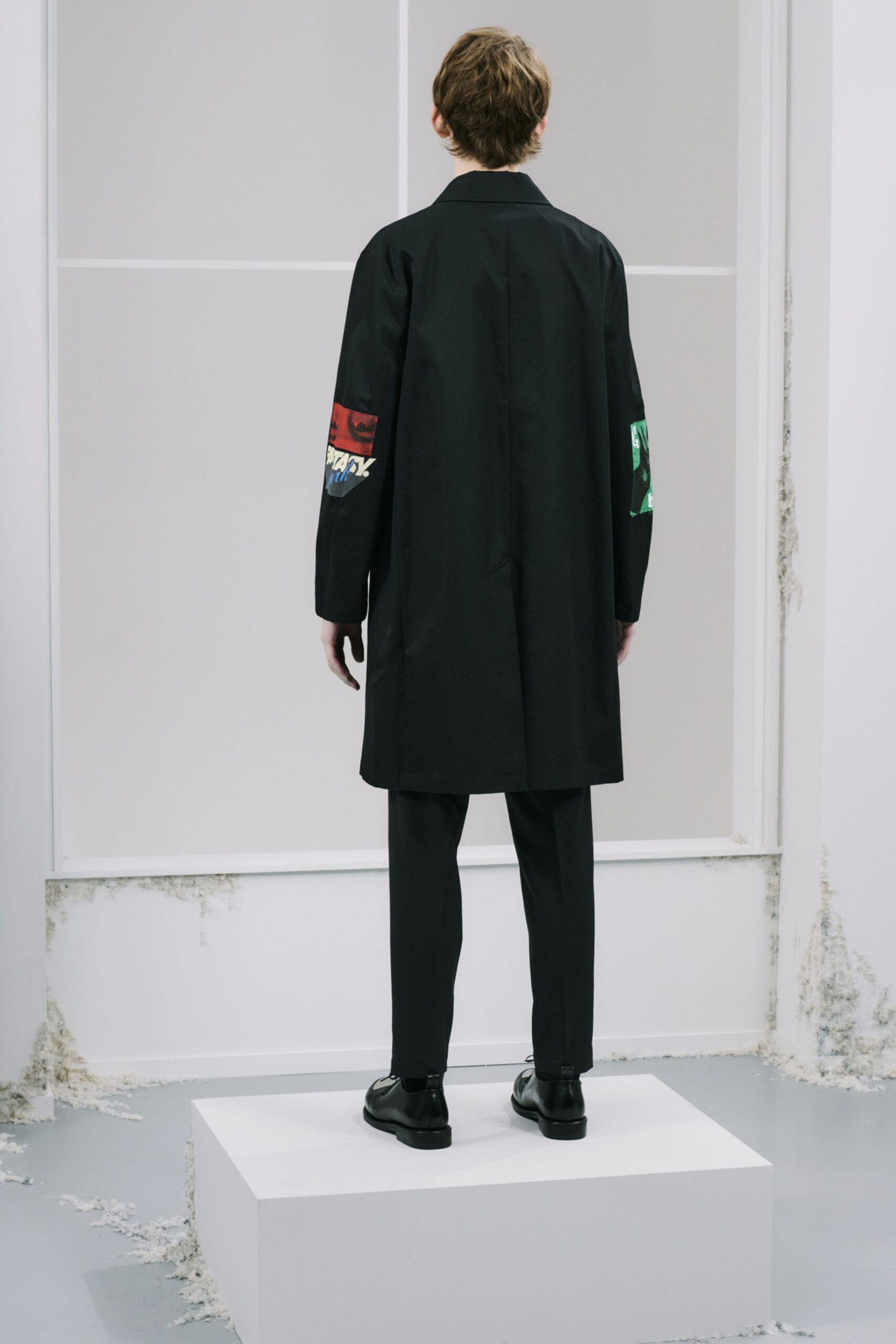 black coat and tailored pants