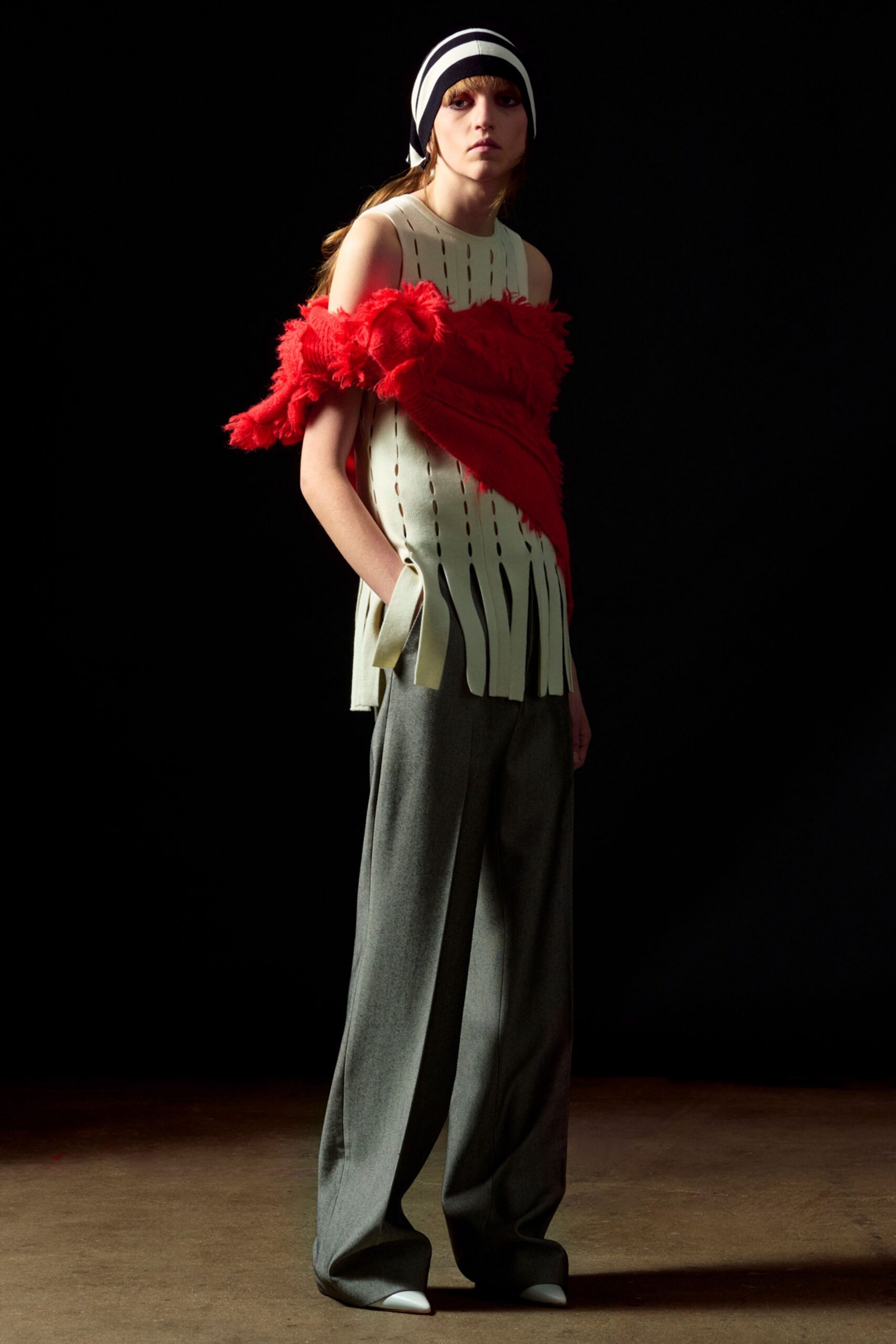 white top with red ruffles and gray pants