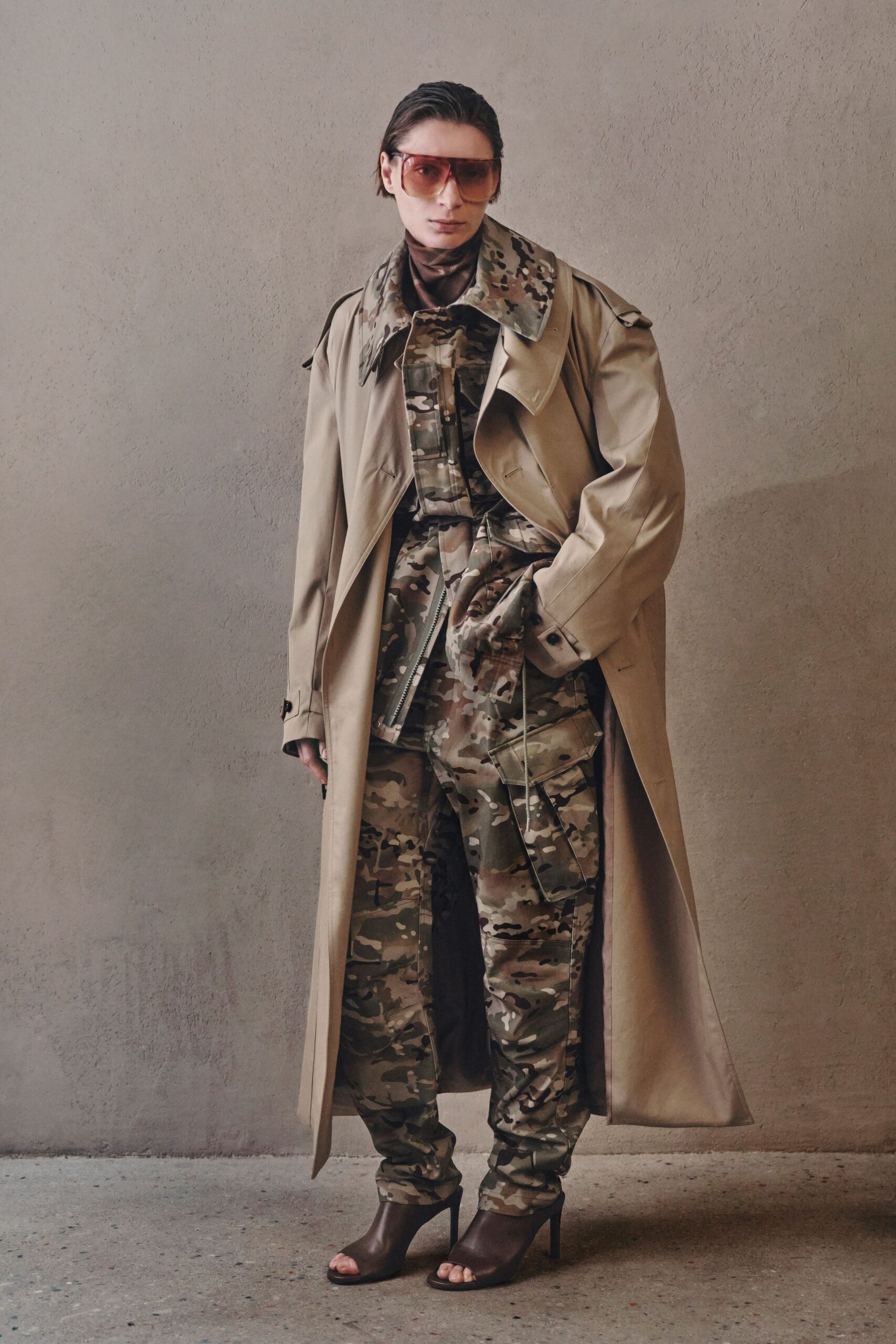 beige trench coat and camouflage jumpsuit