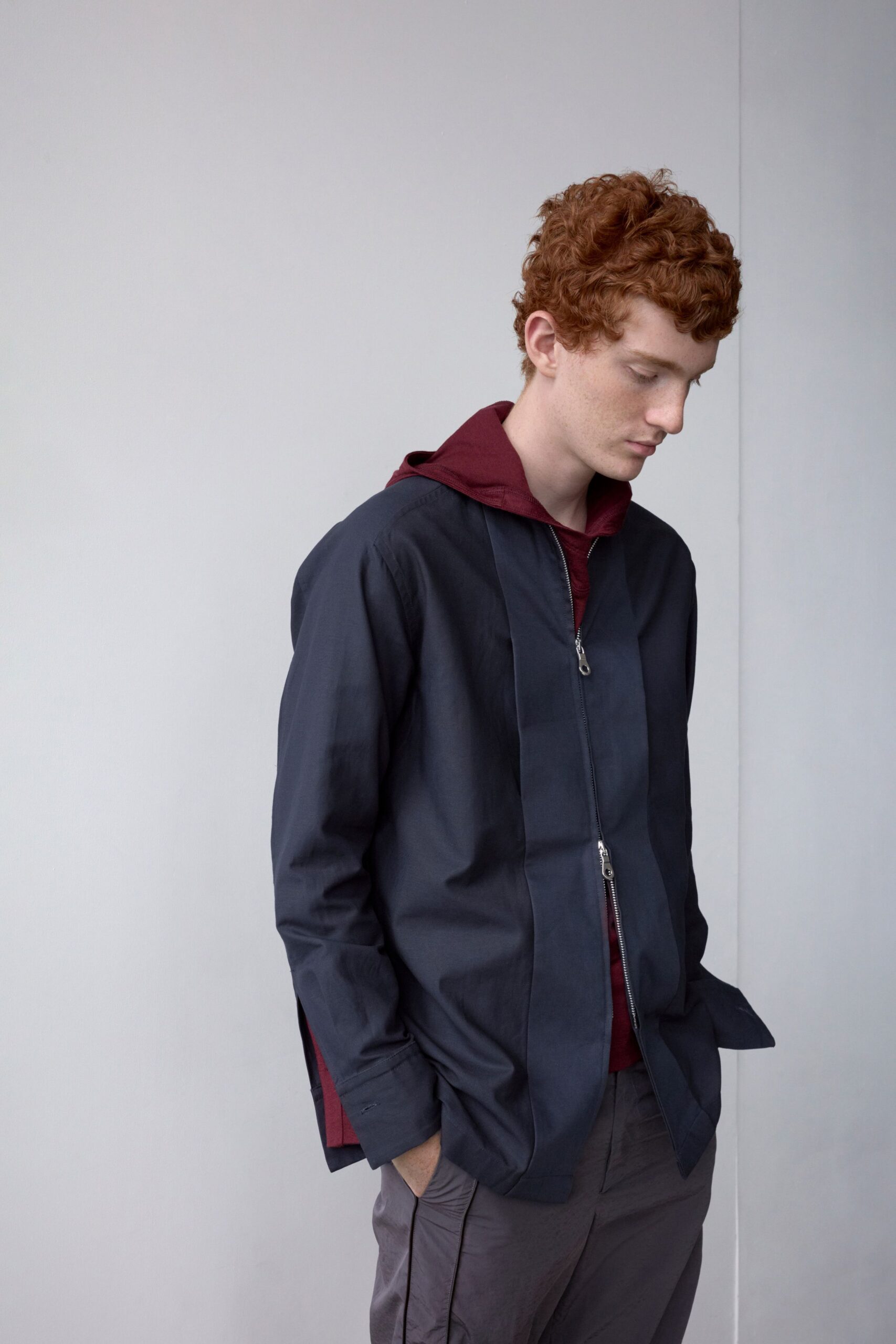 black jacket red hoodie gray pants