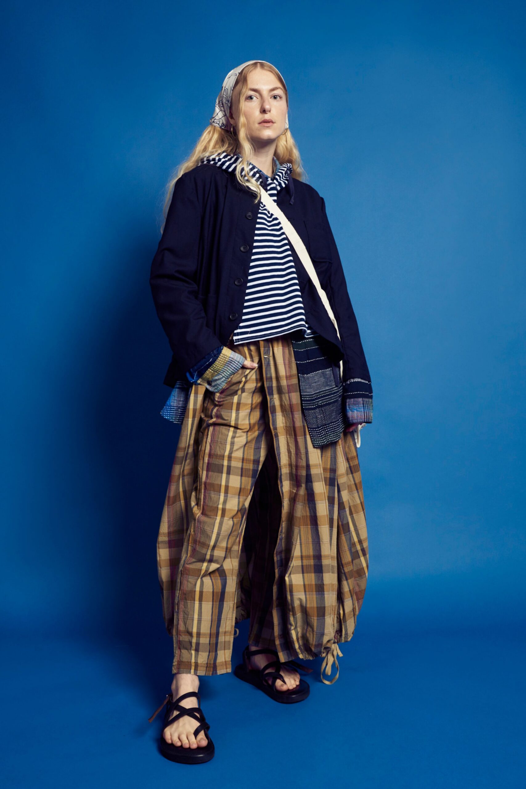 black jacket gray hoodie plaid pants