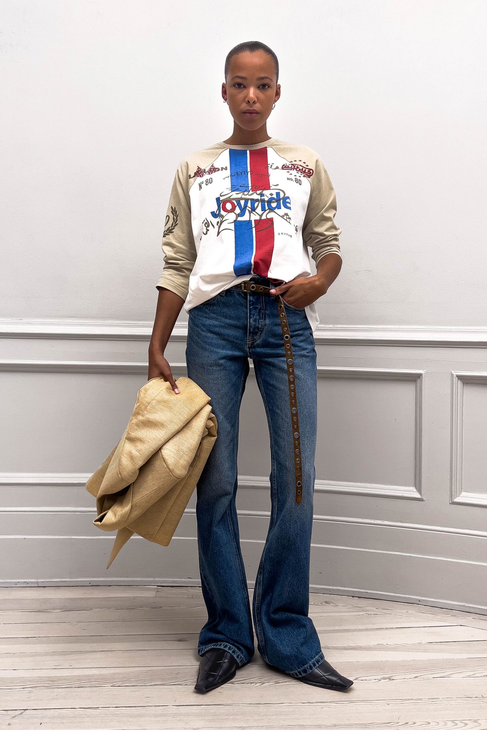 beige printed top with flared jeans
