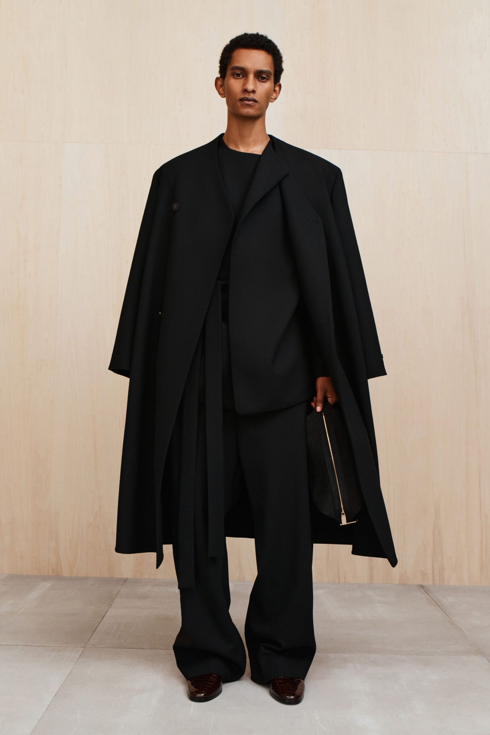 black oversized coat and tailored suit