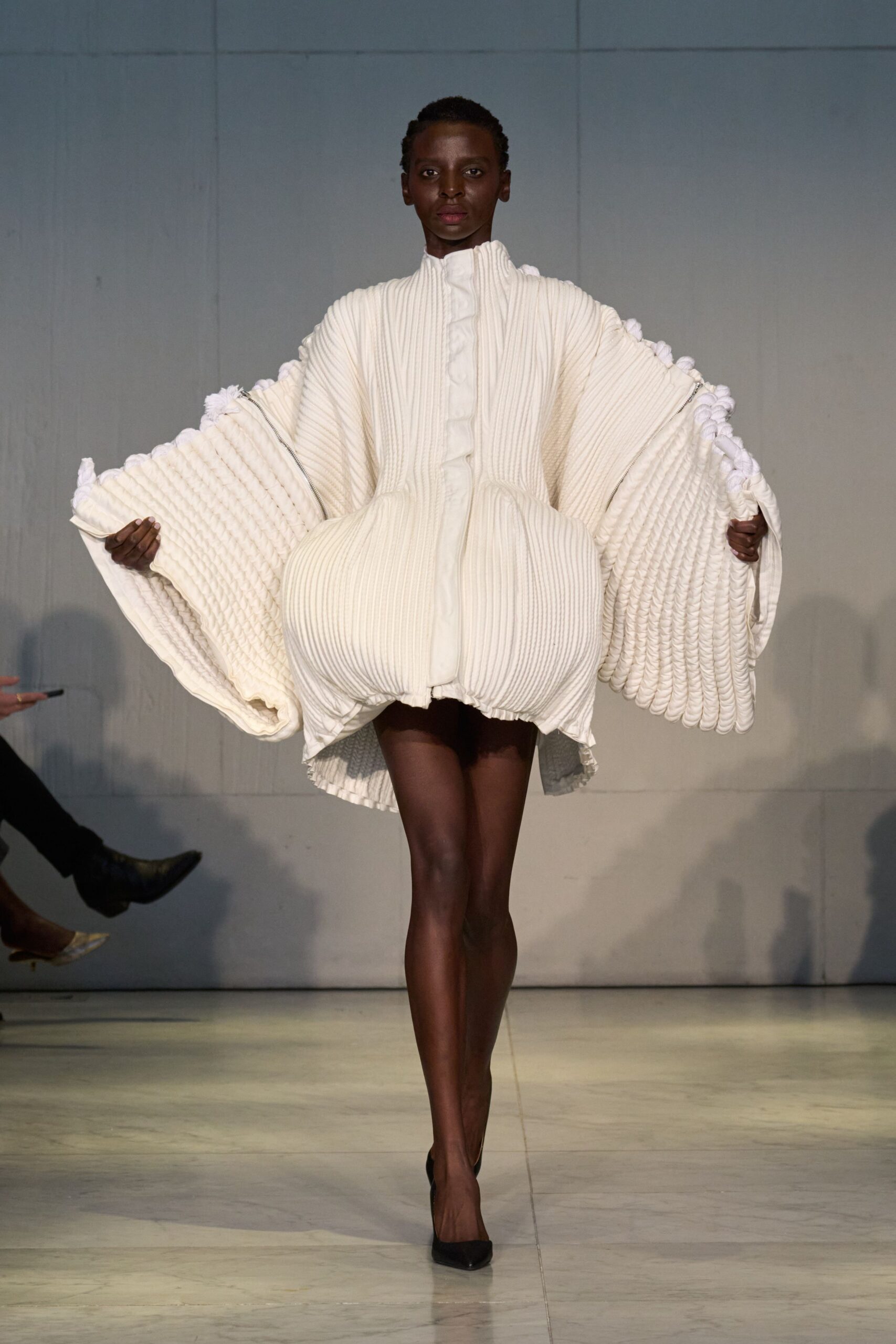 white pleated mini dress with black shoes
