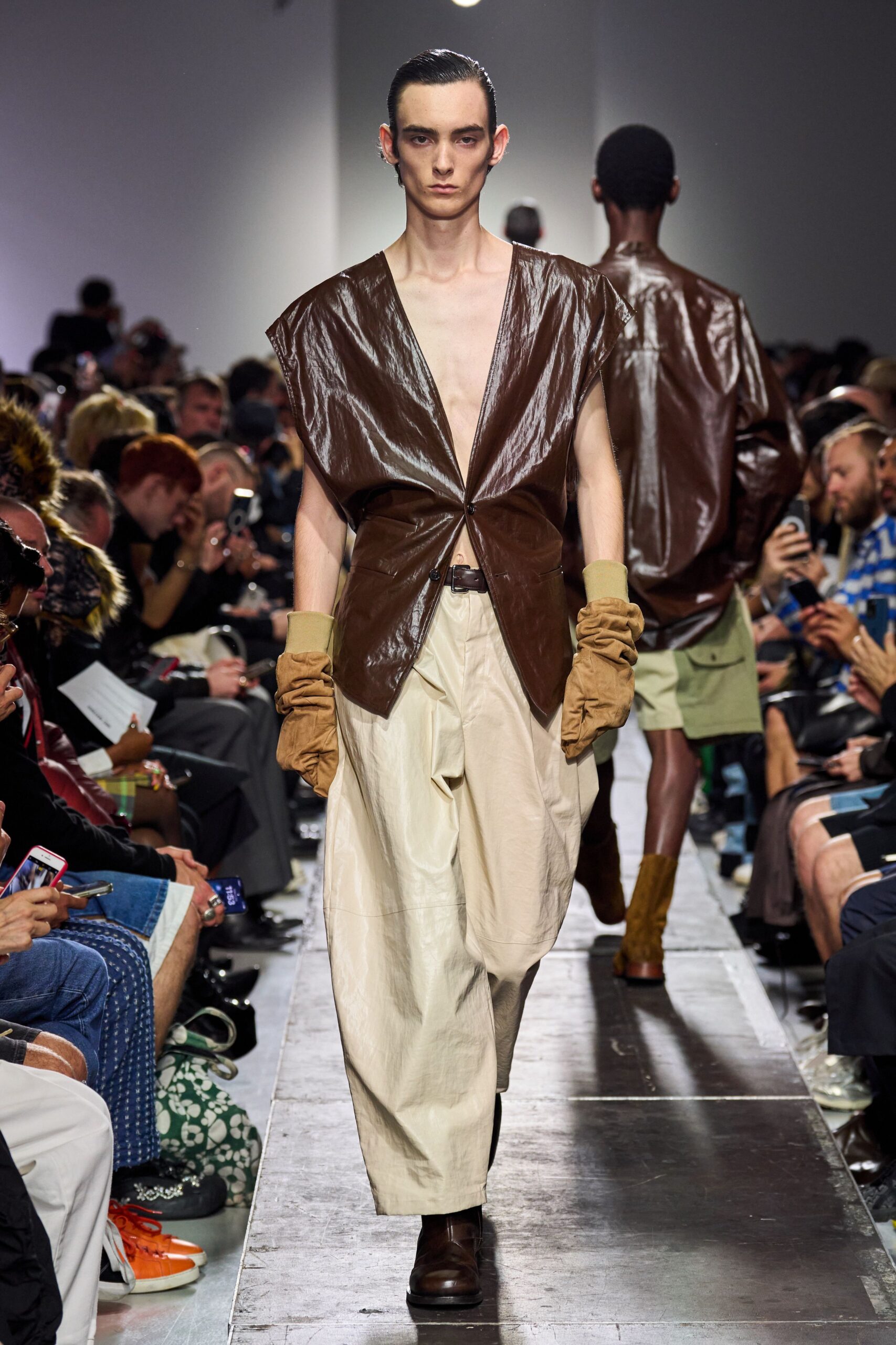brown leather sleeveless top and beige wide-leg pants