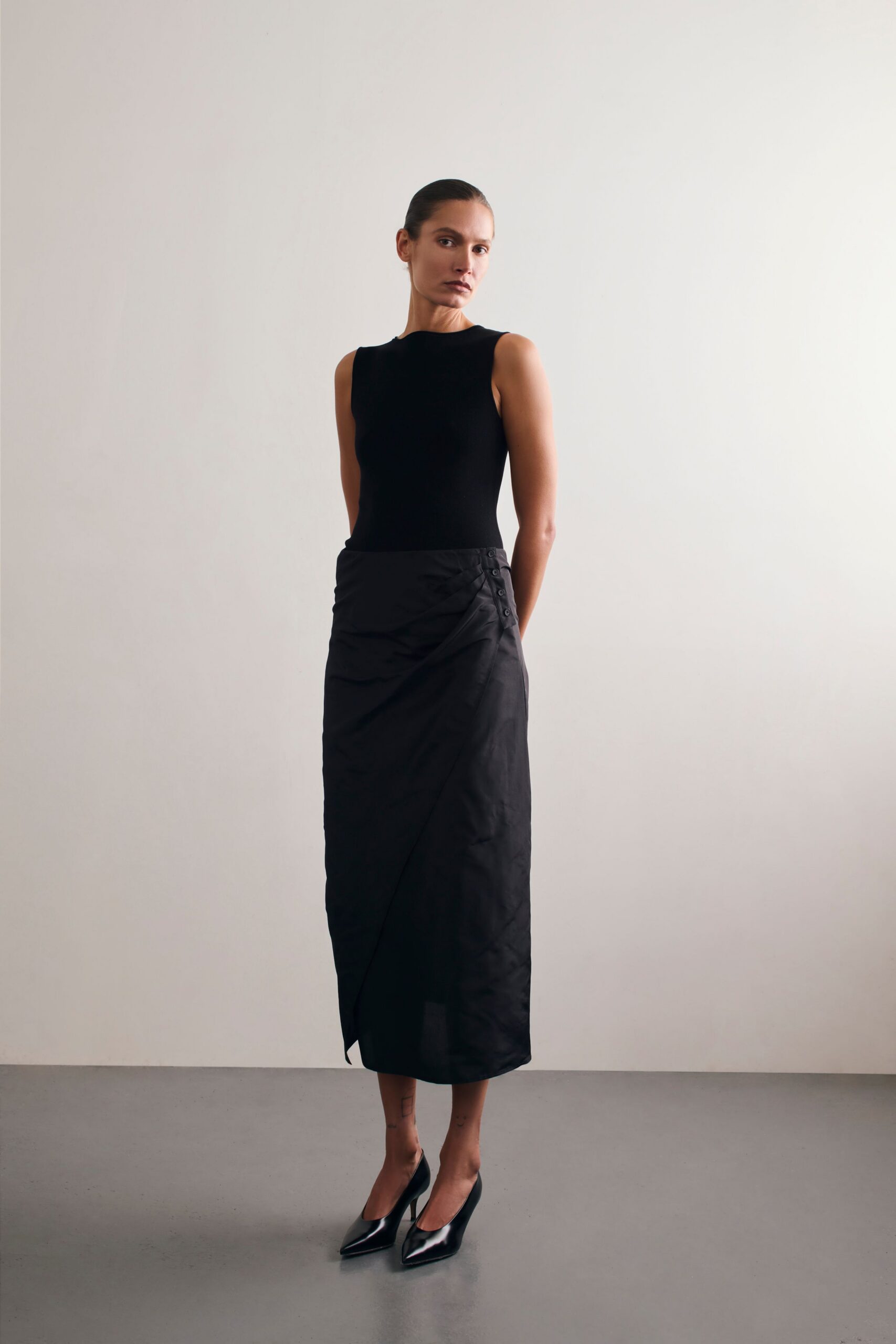 black silk asymmetric fitted high-waisted draped midi skirt