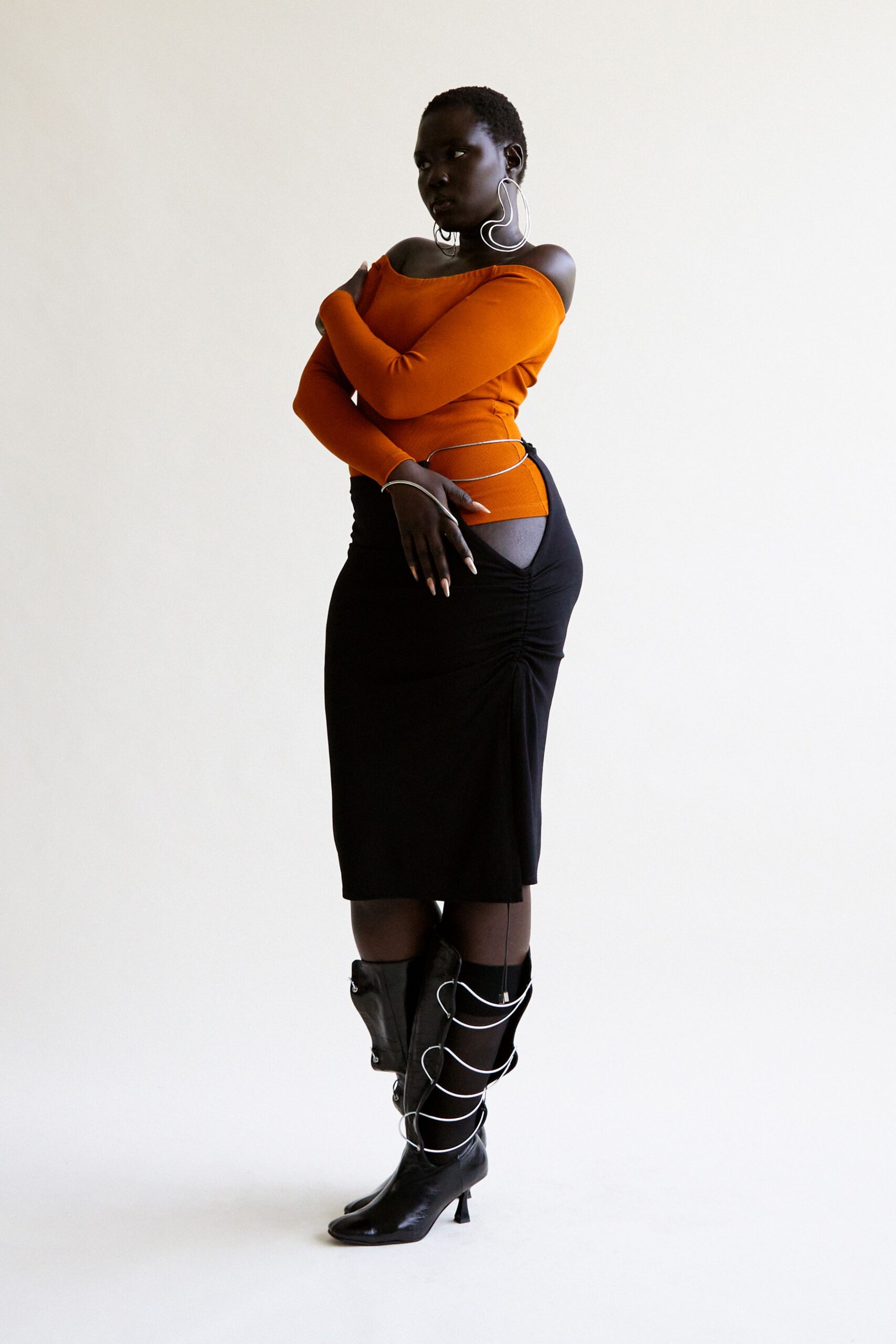 orange fitted top black midi skirt