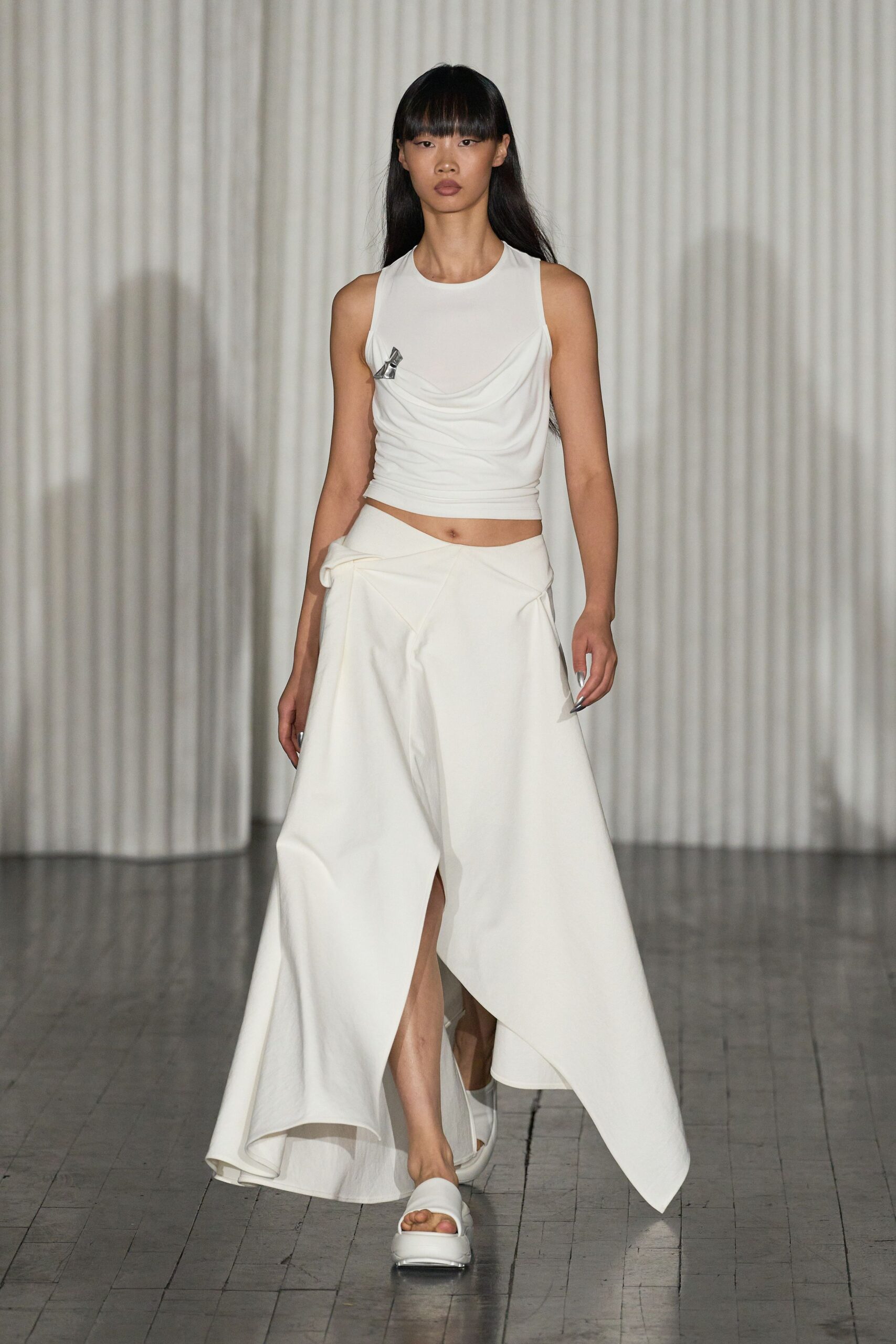 white draped top and asymmetric skirt