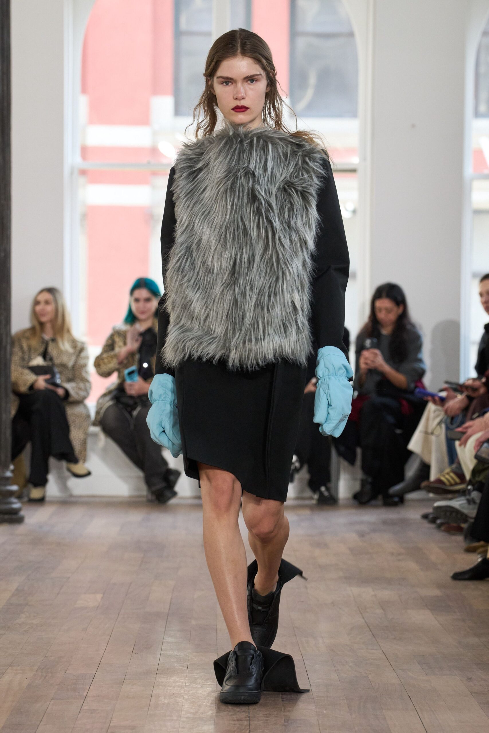 black fitted dress with gray faux-fur cape