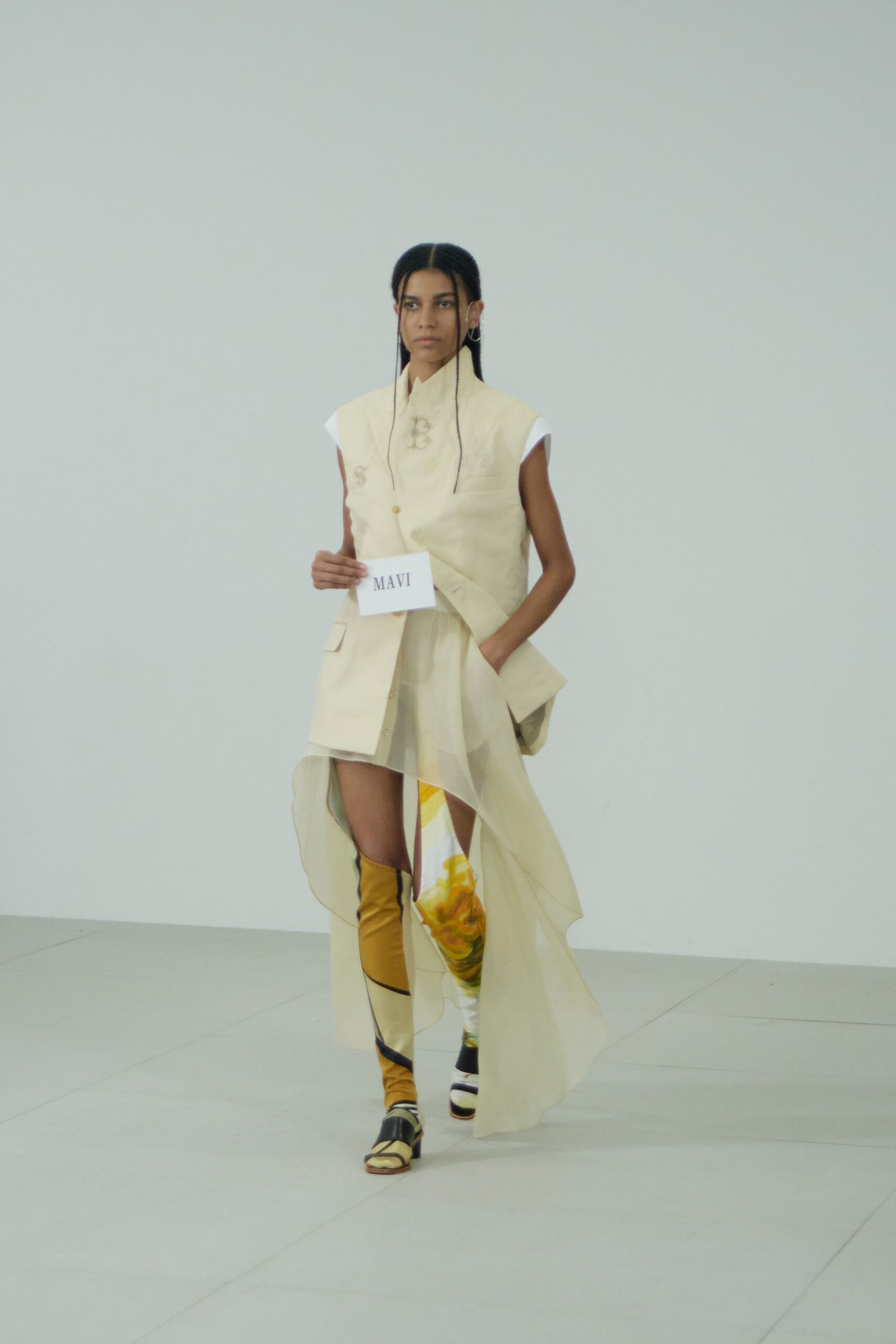 beige asymmetric draped dress with strappy shoes