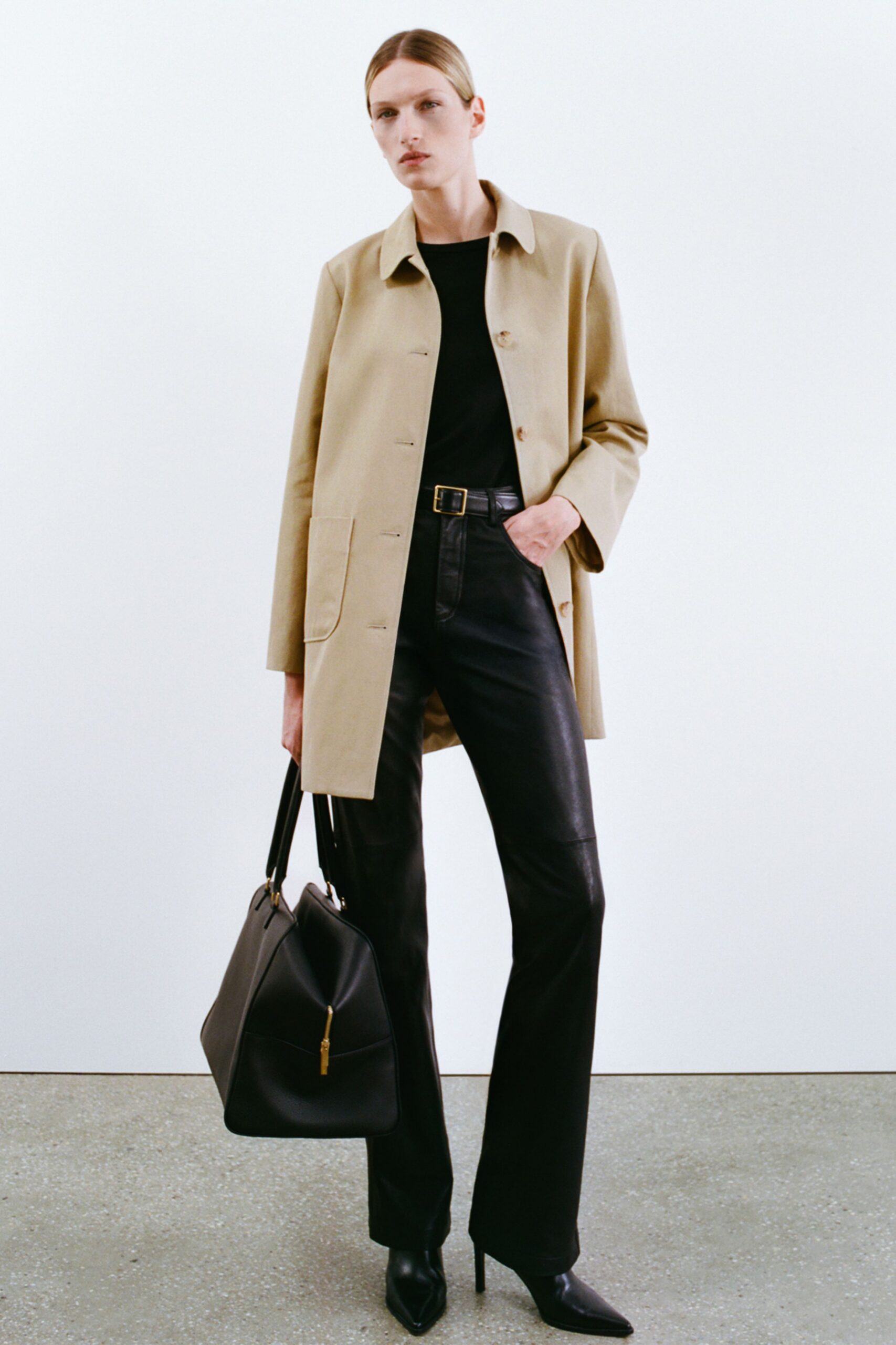 beige coat black top leather pants