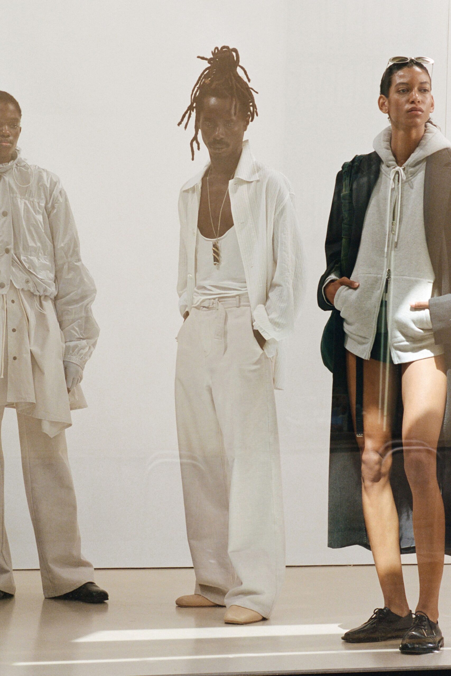 white shirt relaxed pants gray hoodie black coat