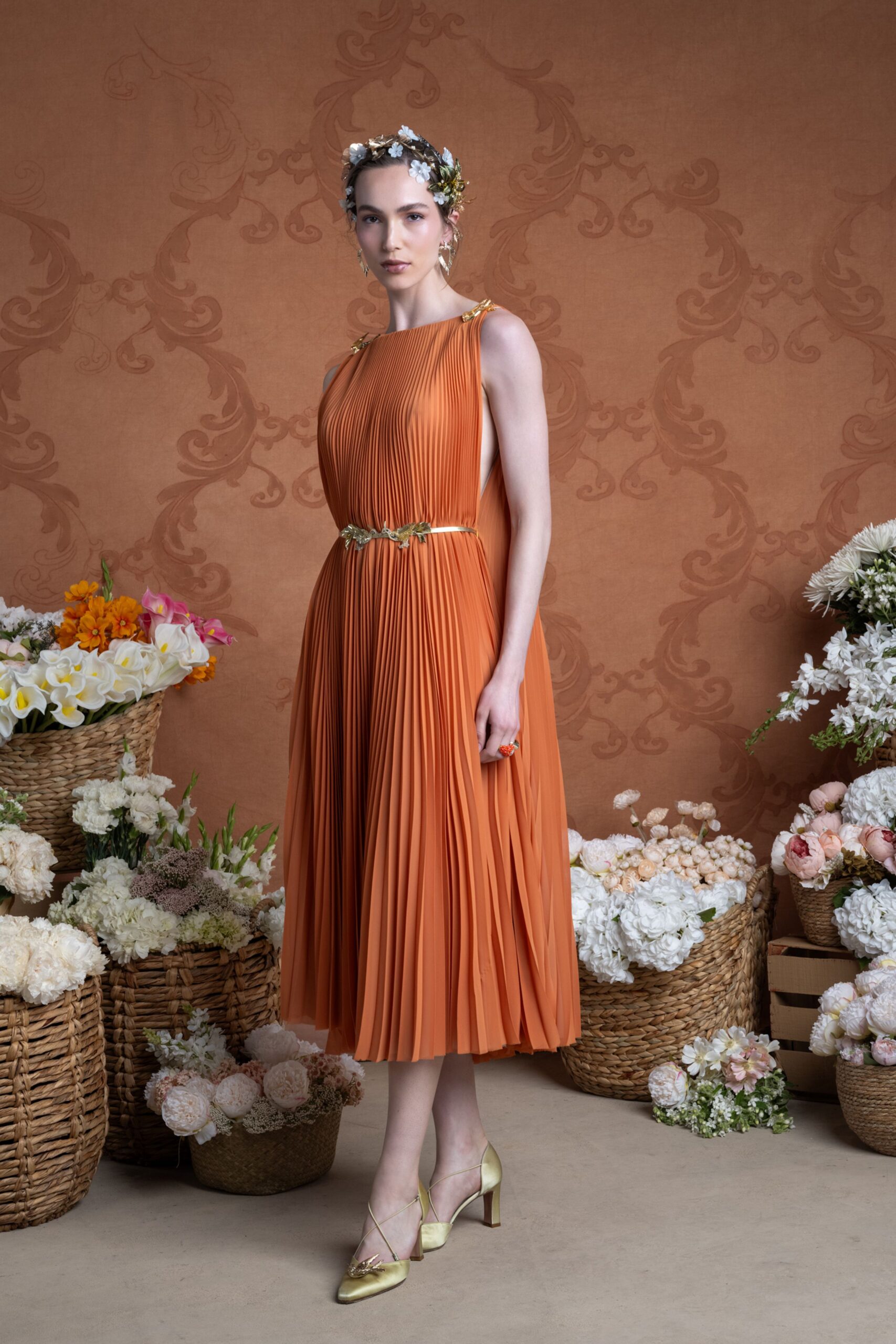 orange pleated midi dress with gold shoes