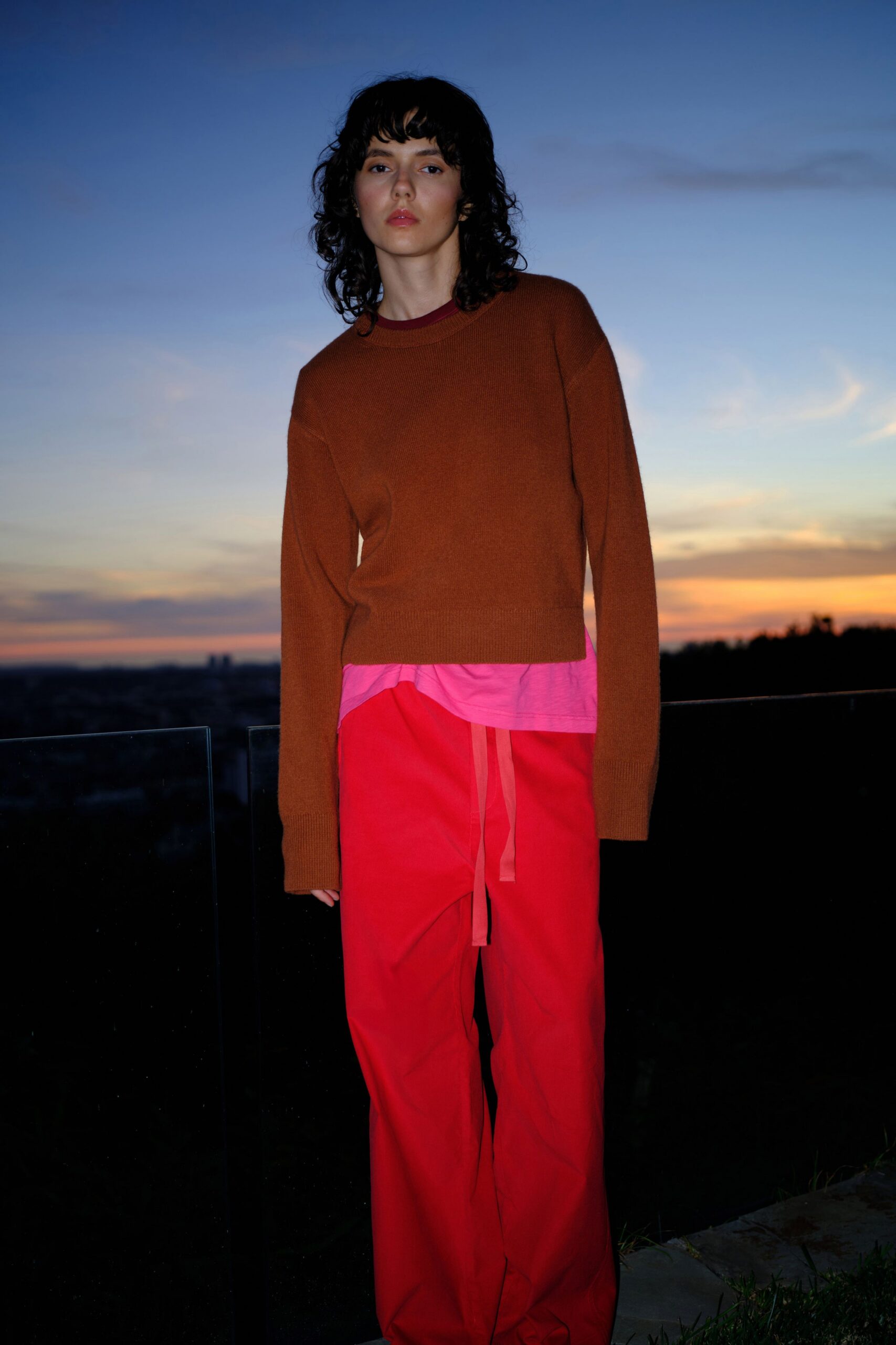 brown relaxed sweater and red pants