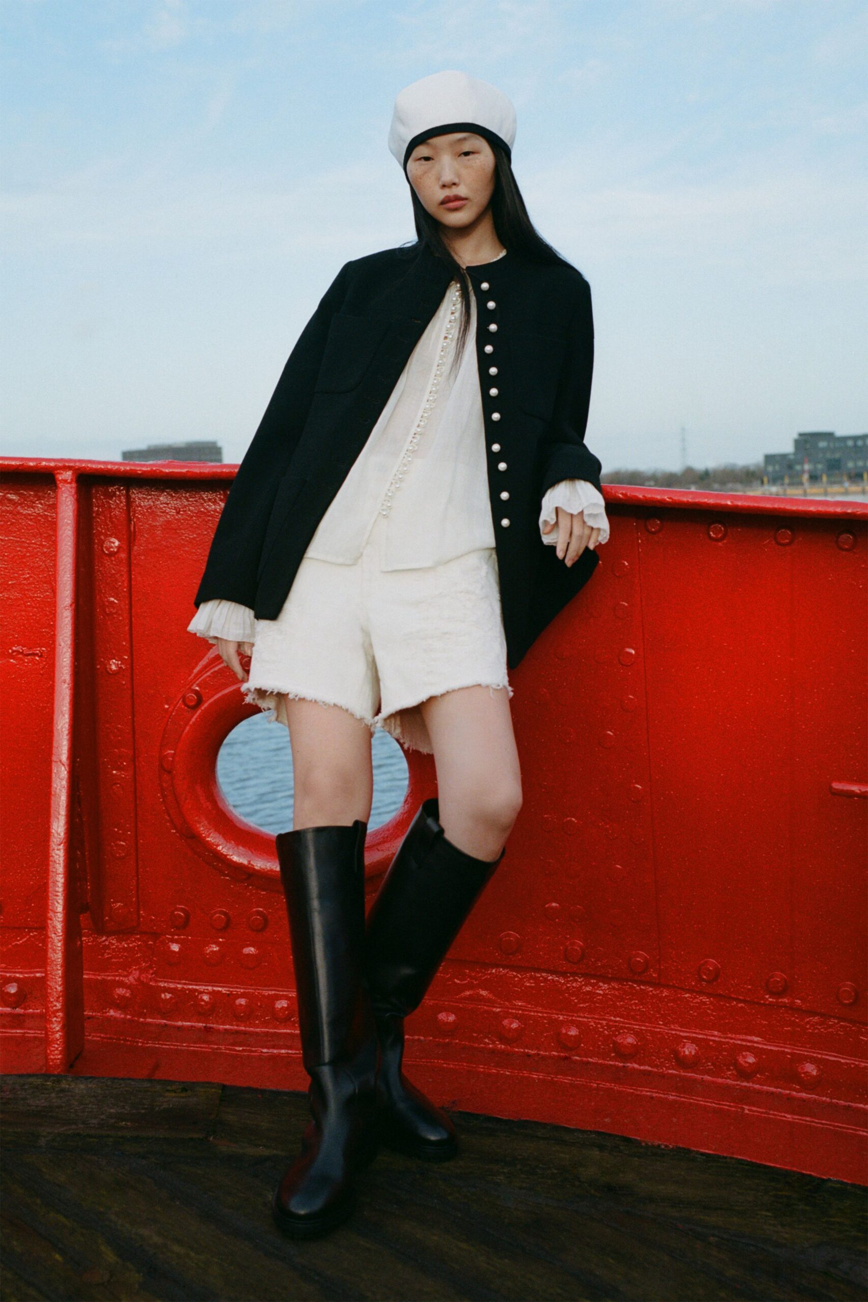 black jacket white blouse shorts