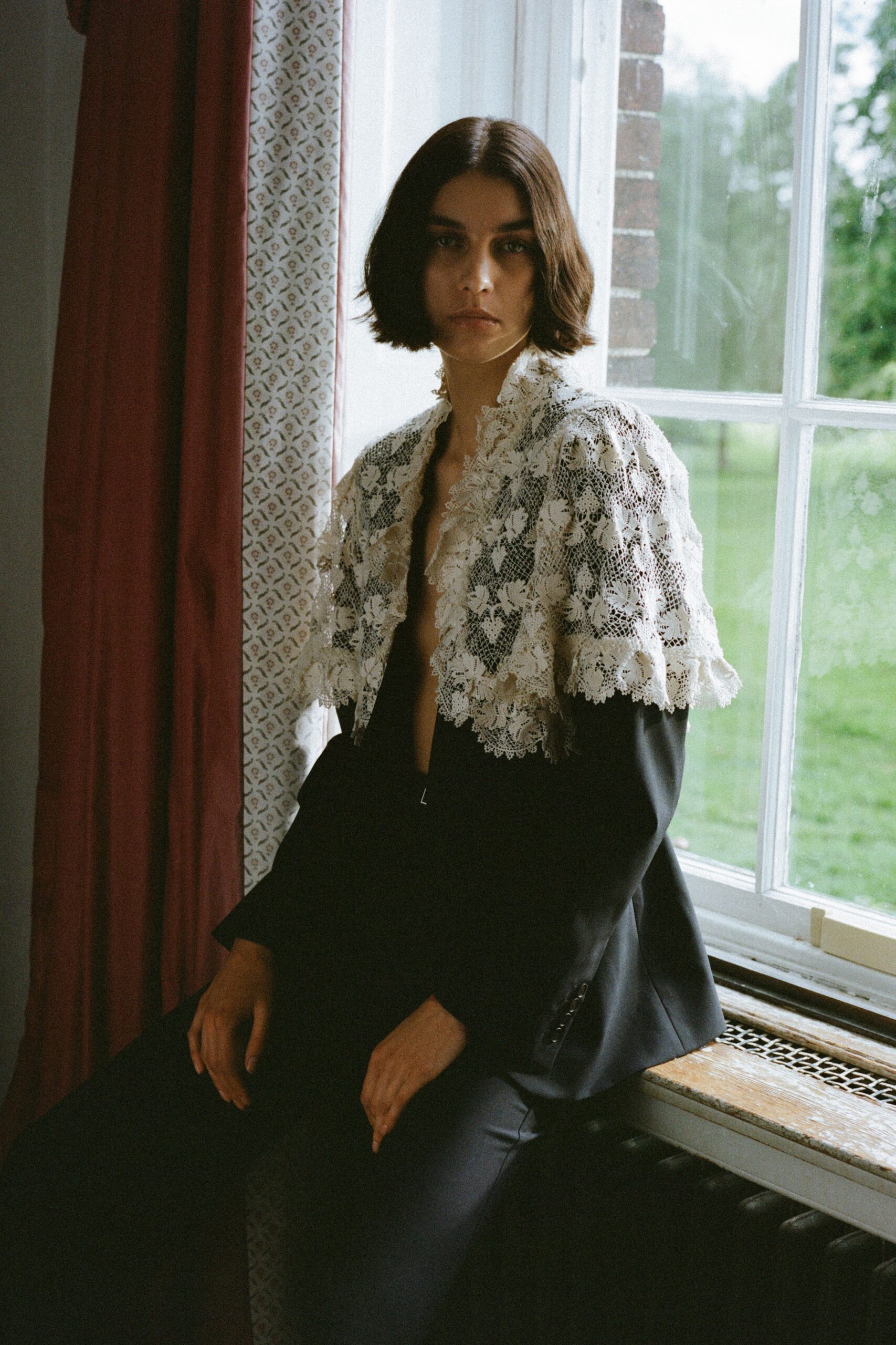 black tailored blazer with white lace cape