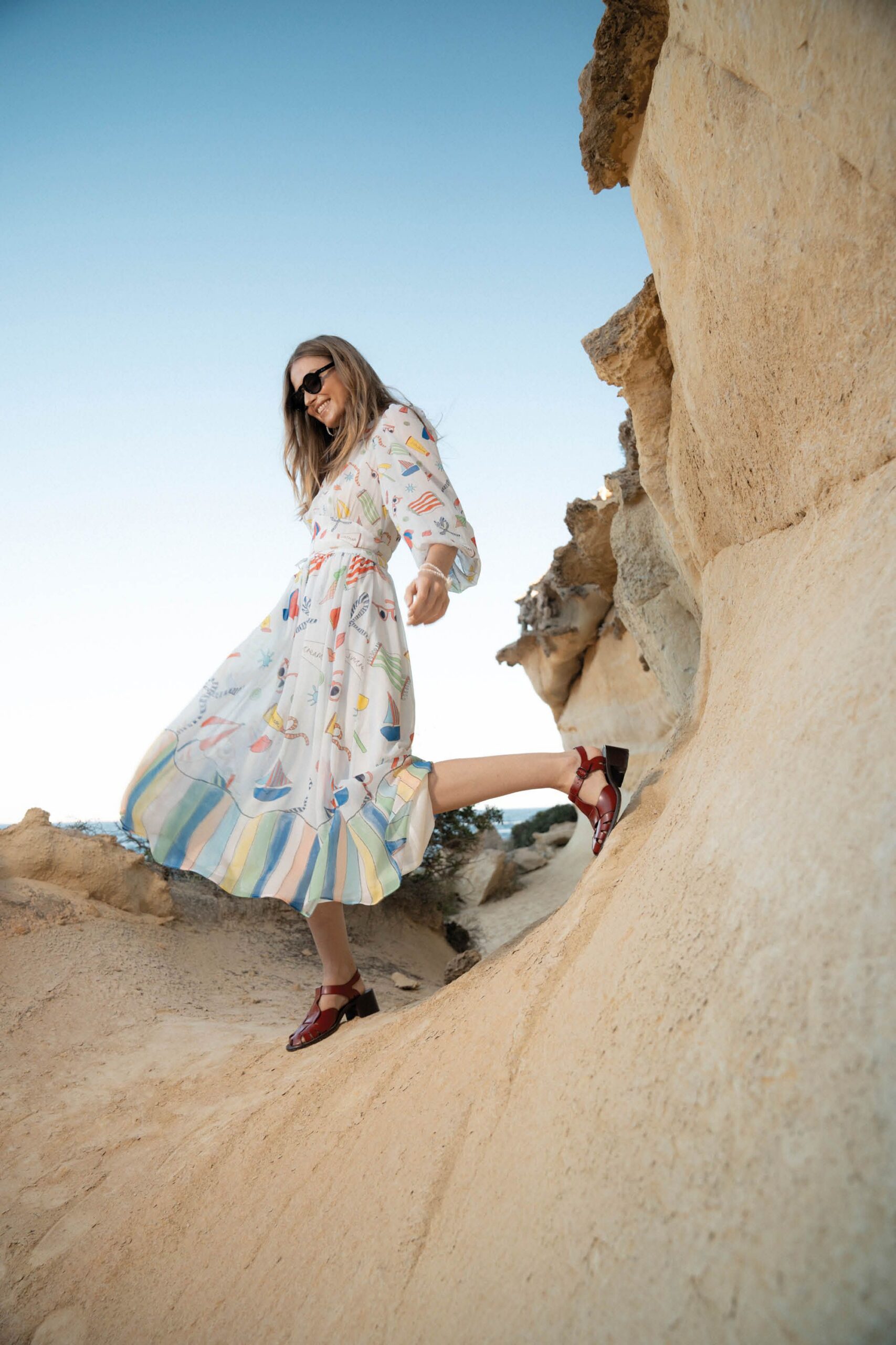 multi-colored midi dress with sunglasses