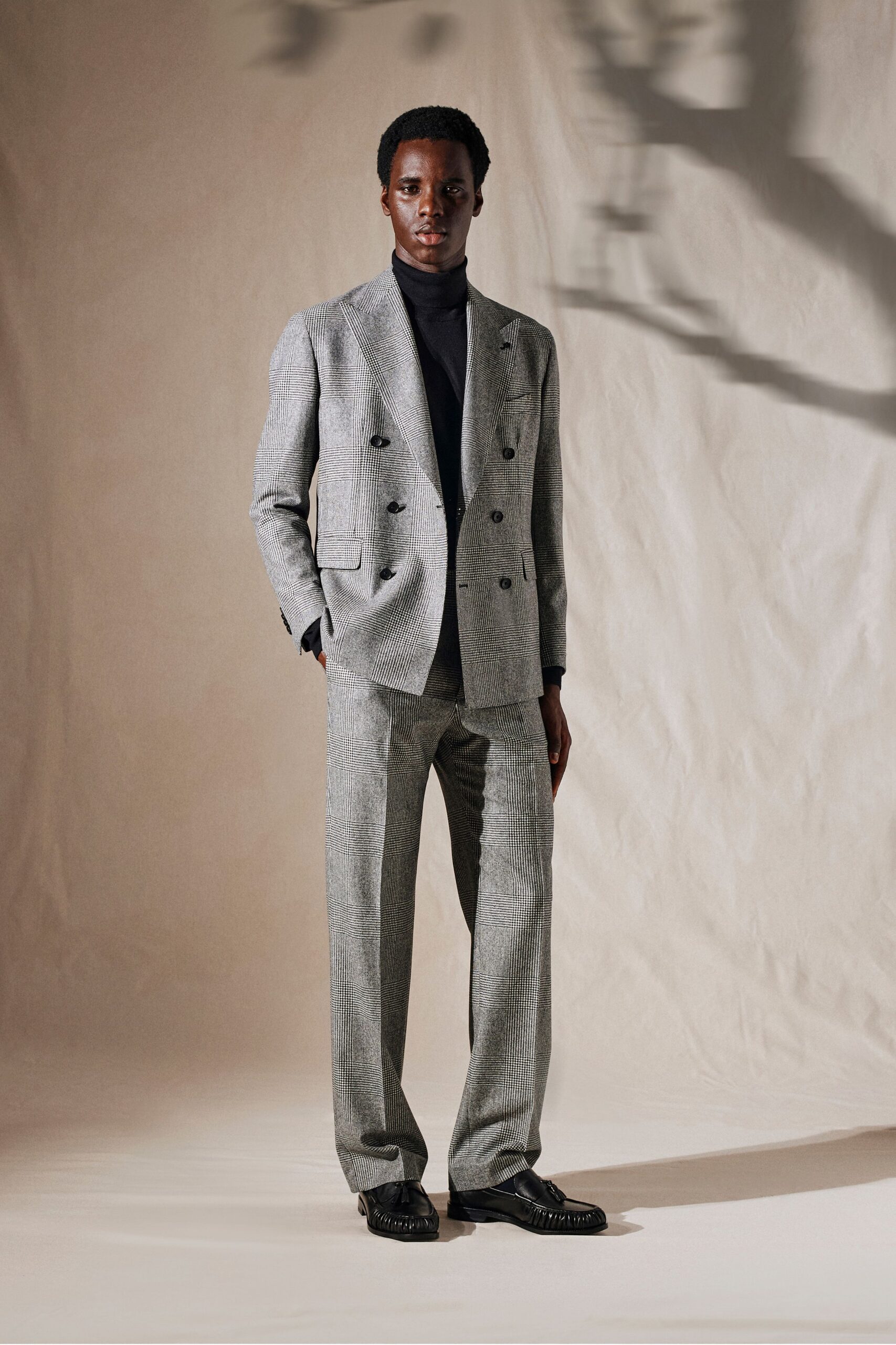 gray tailored suit with black turtleneck