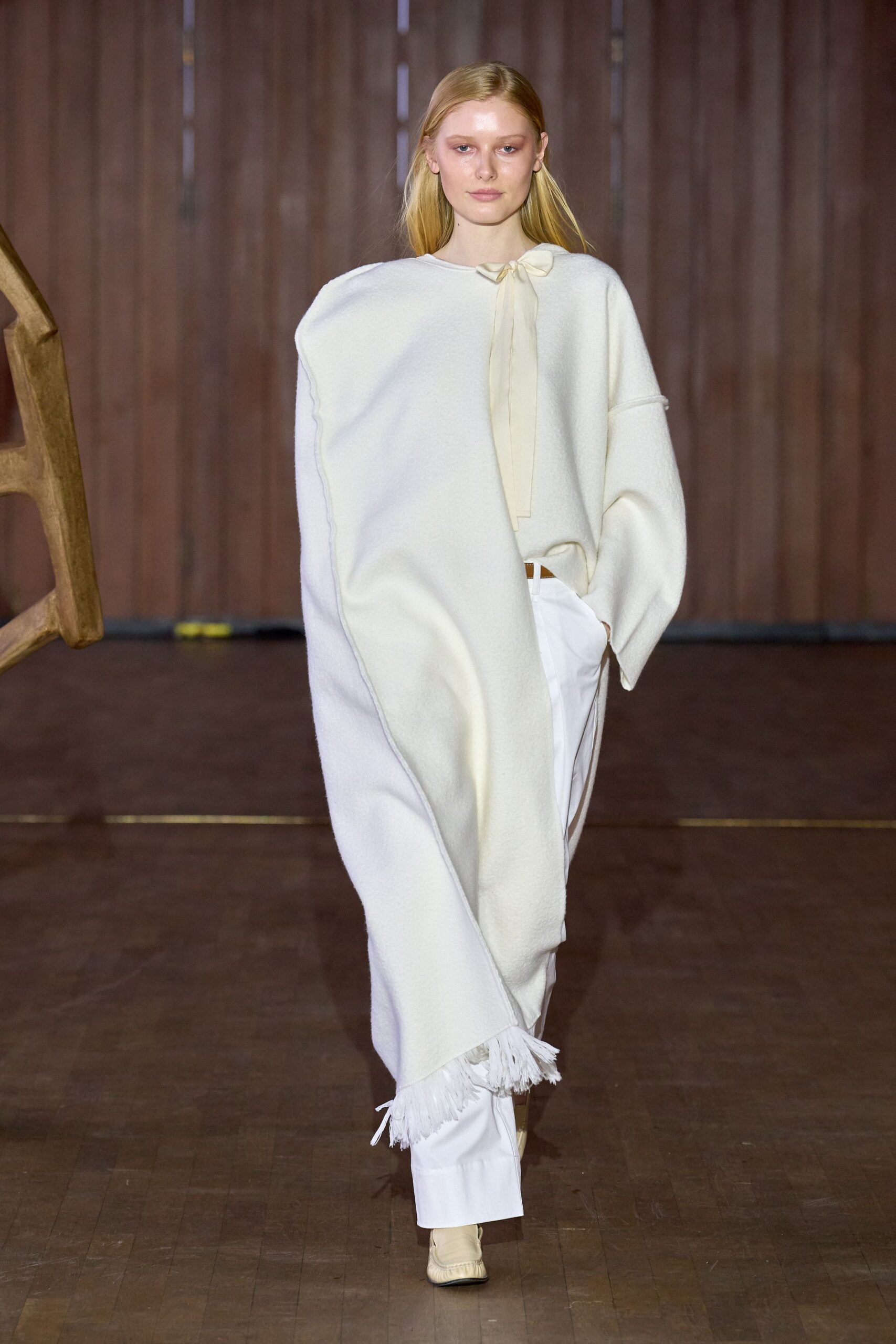 white wool poncho with tailored pants