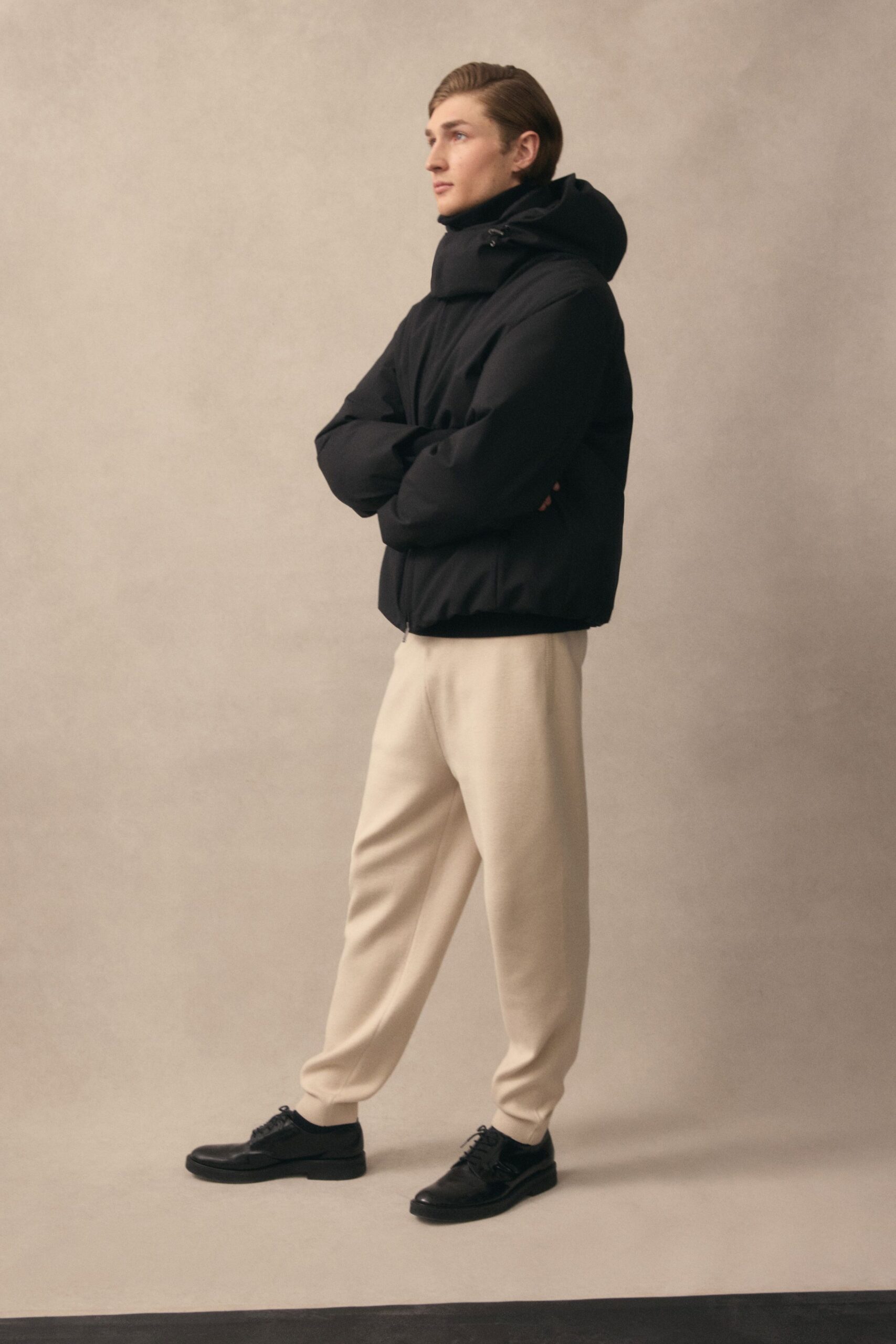 black hooded jacket beige pants